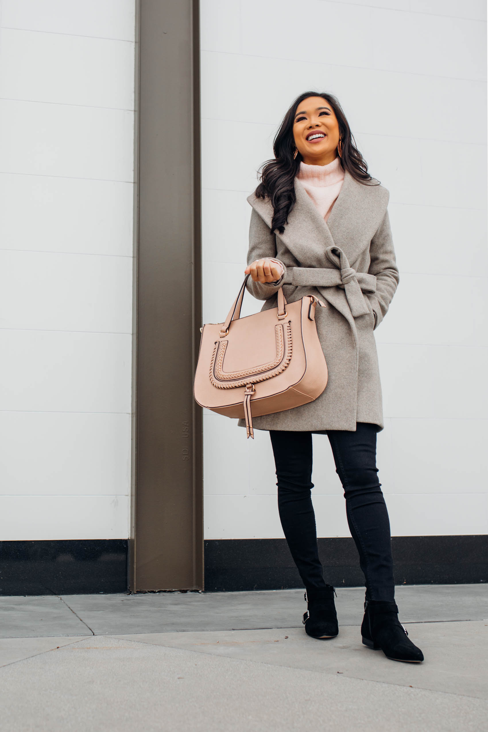 Blogger Hoang-Kim shares a winter outfit idea with an Ann Taylor wool wrap coat and blush handbag
