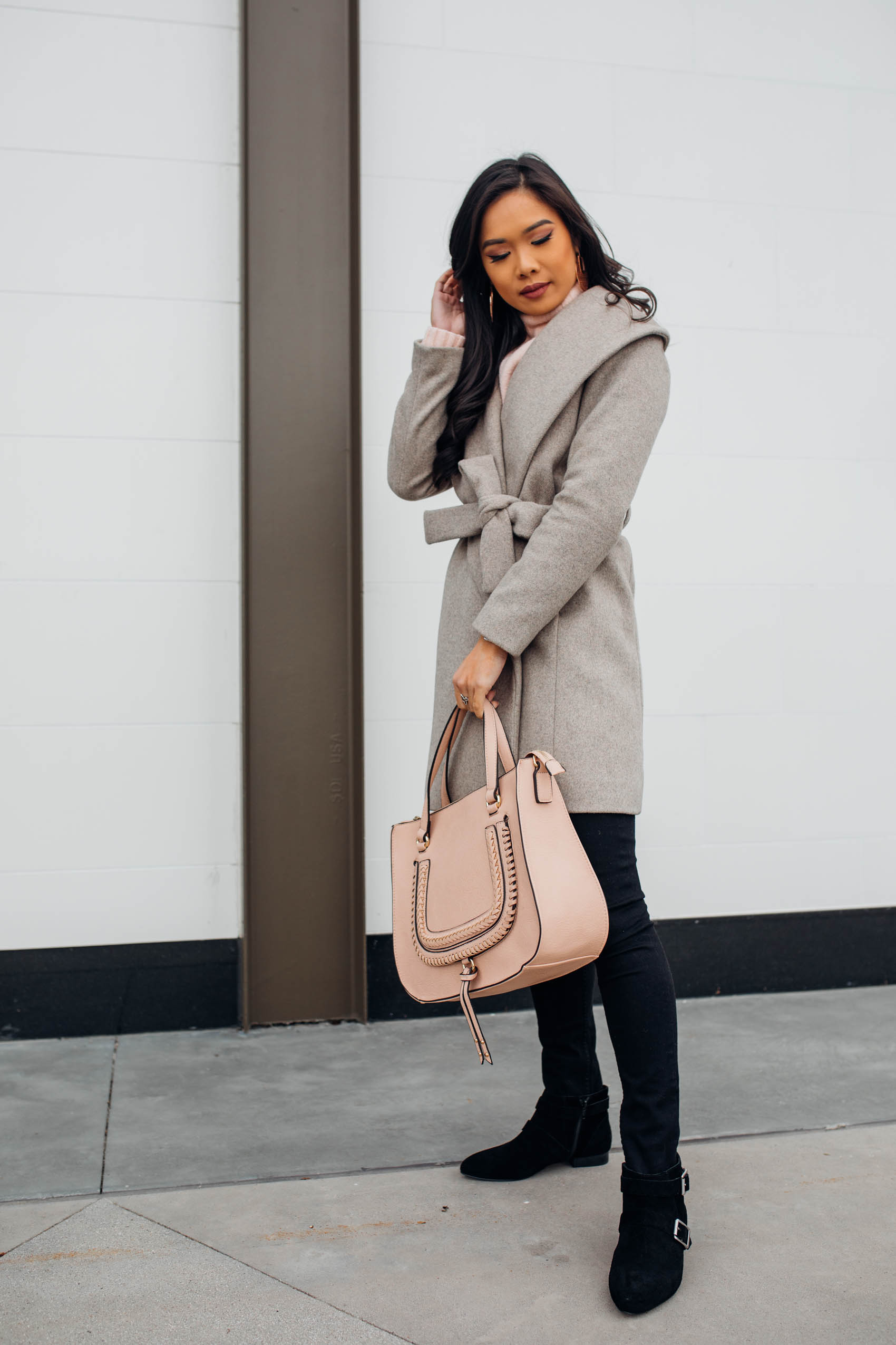 Blogger Hoang-Kim shares a winter outfit idea with a wool wrap coat and Destin satchel by Sole Society