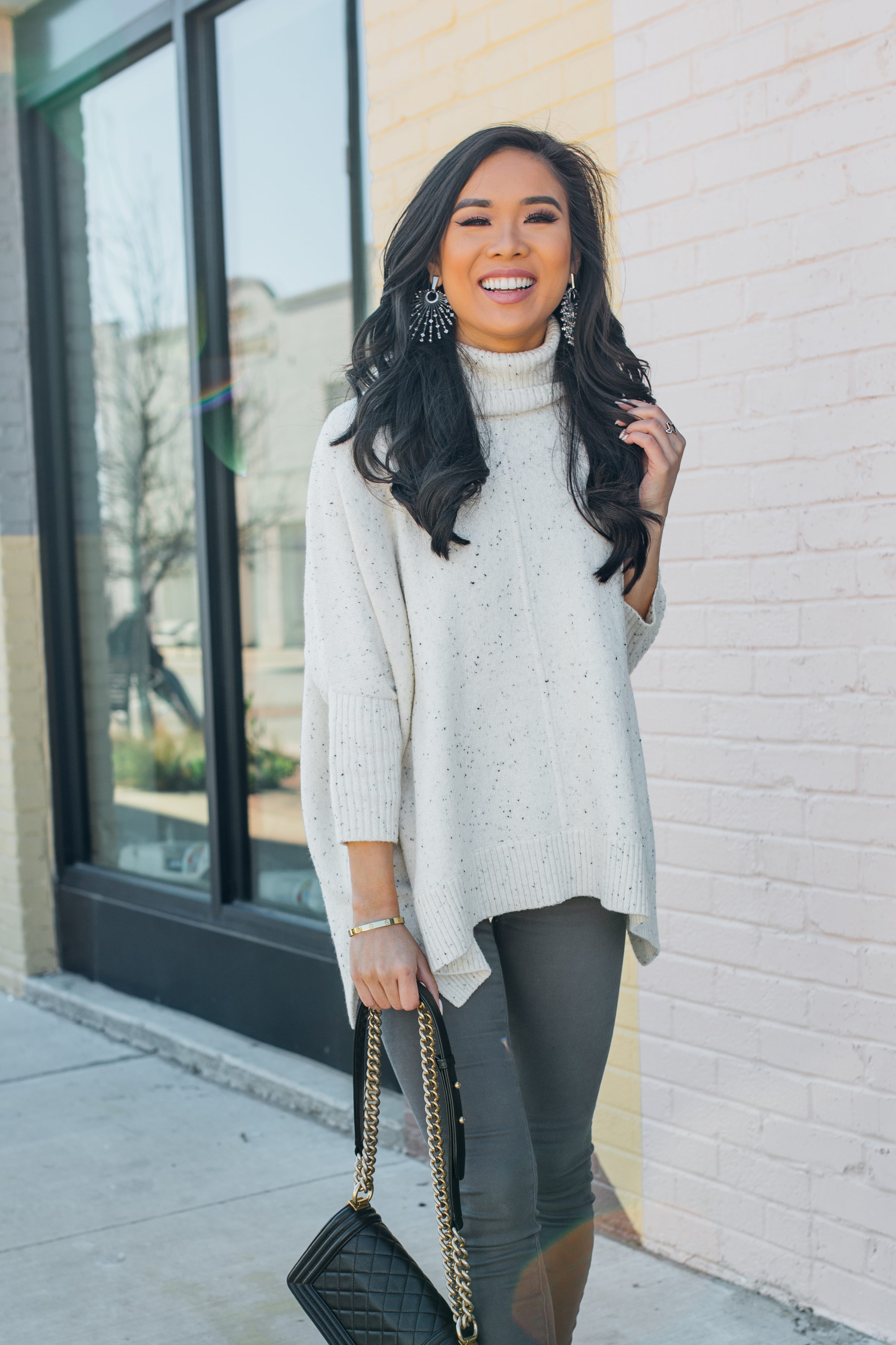 Blogger Hoang-Kim shares a casual winter outfit featuring a turtleneck poncho