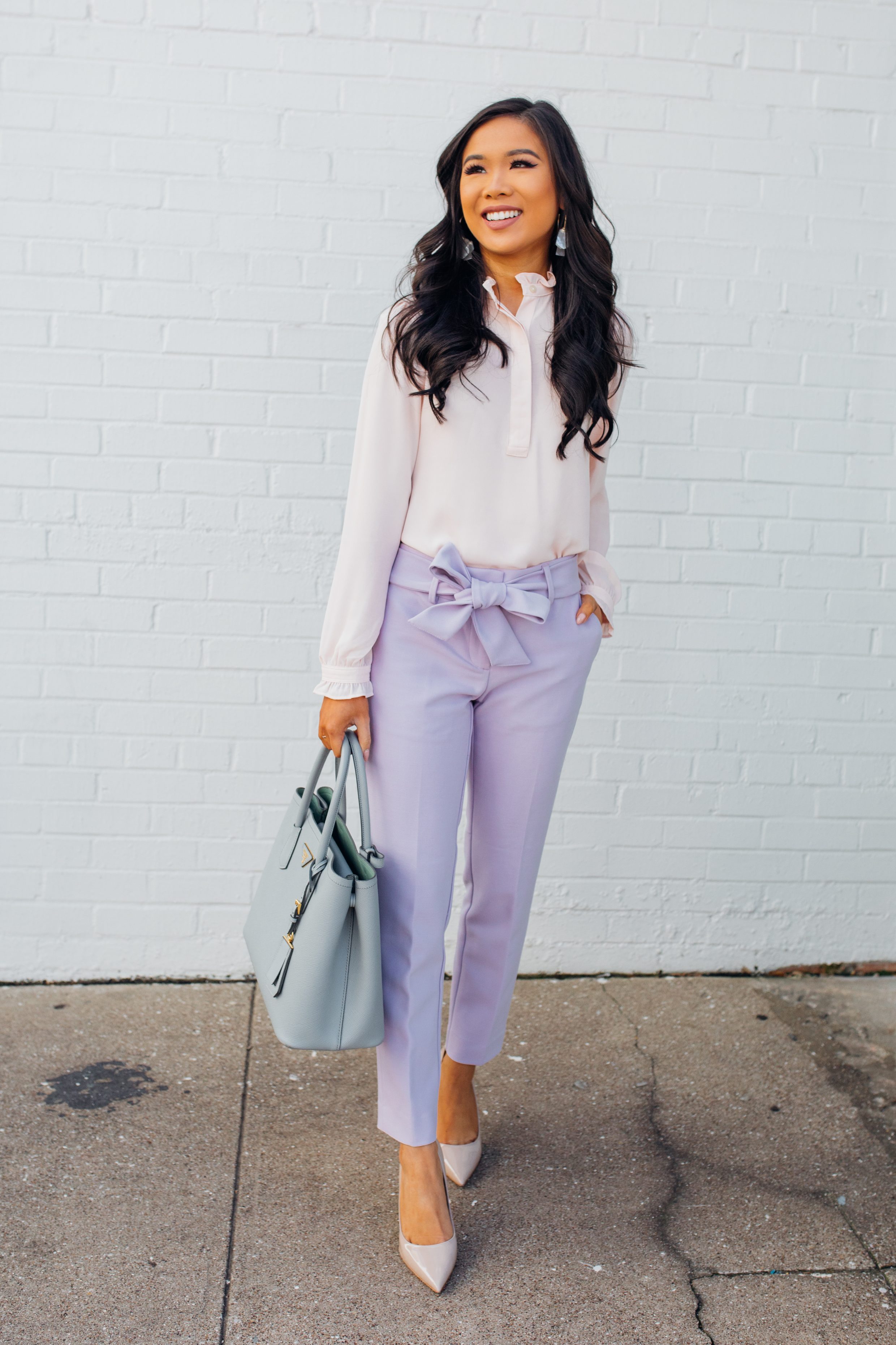 Asian woman wearing a pastel pink blouse with lavender pants for spring