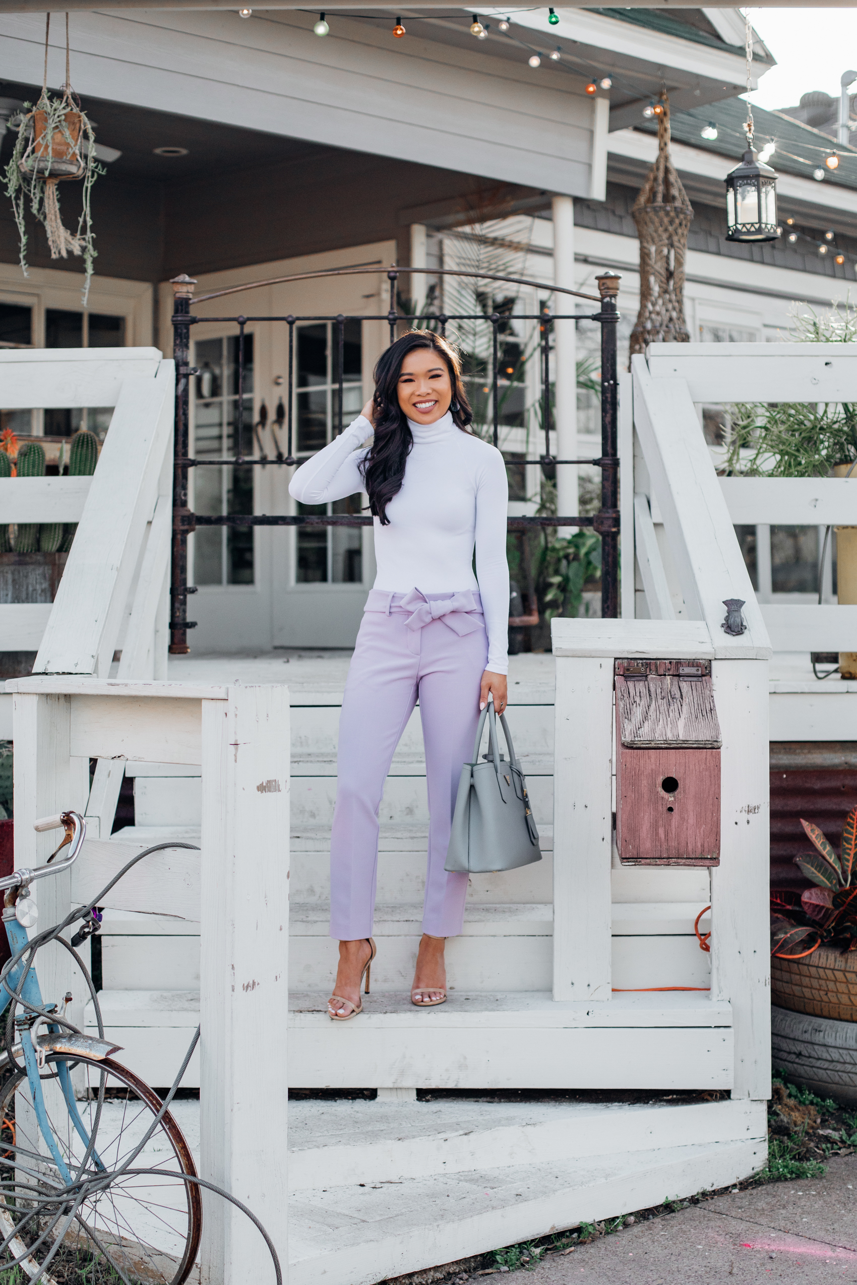 Blogger Hoang-Kim wears lavender tie waist pants with a white bodysuit