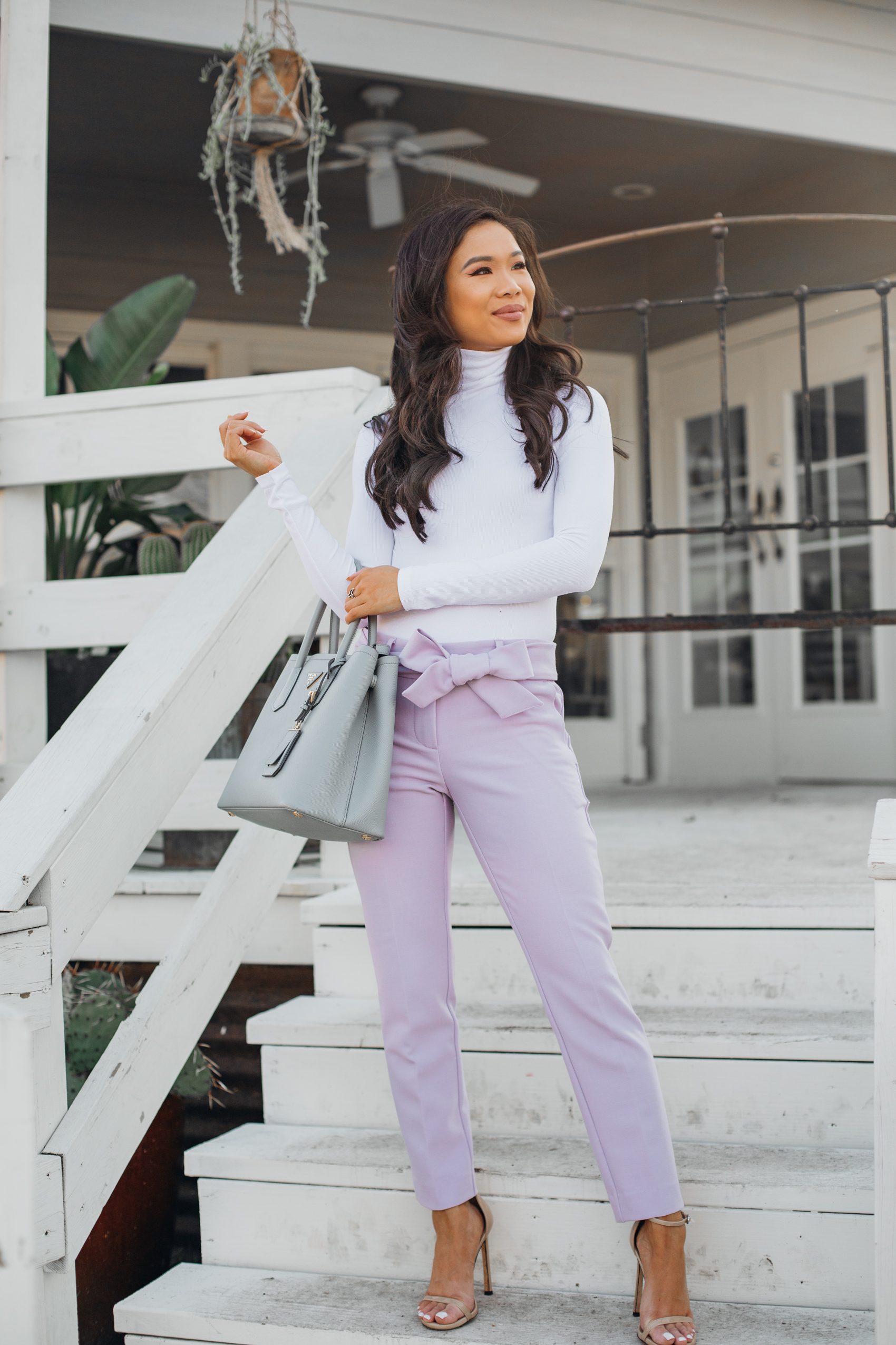 Asian woman wearing lavender pants with a white bodysuit