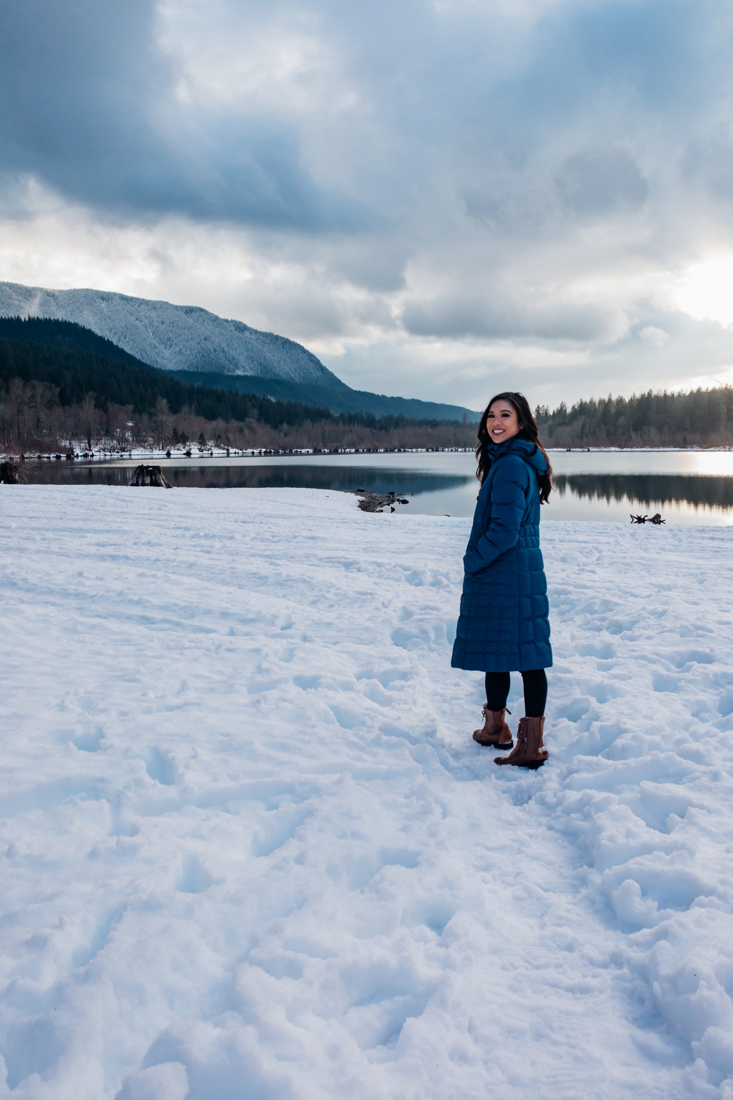 Hoang-Kim explores Rattlesnake Lake during winter wearing a blue Patagonia parka