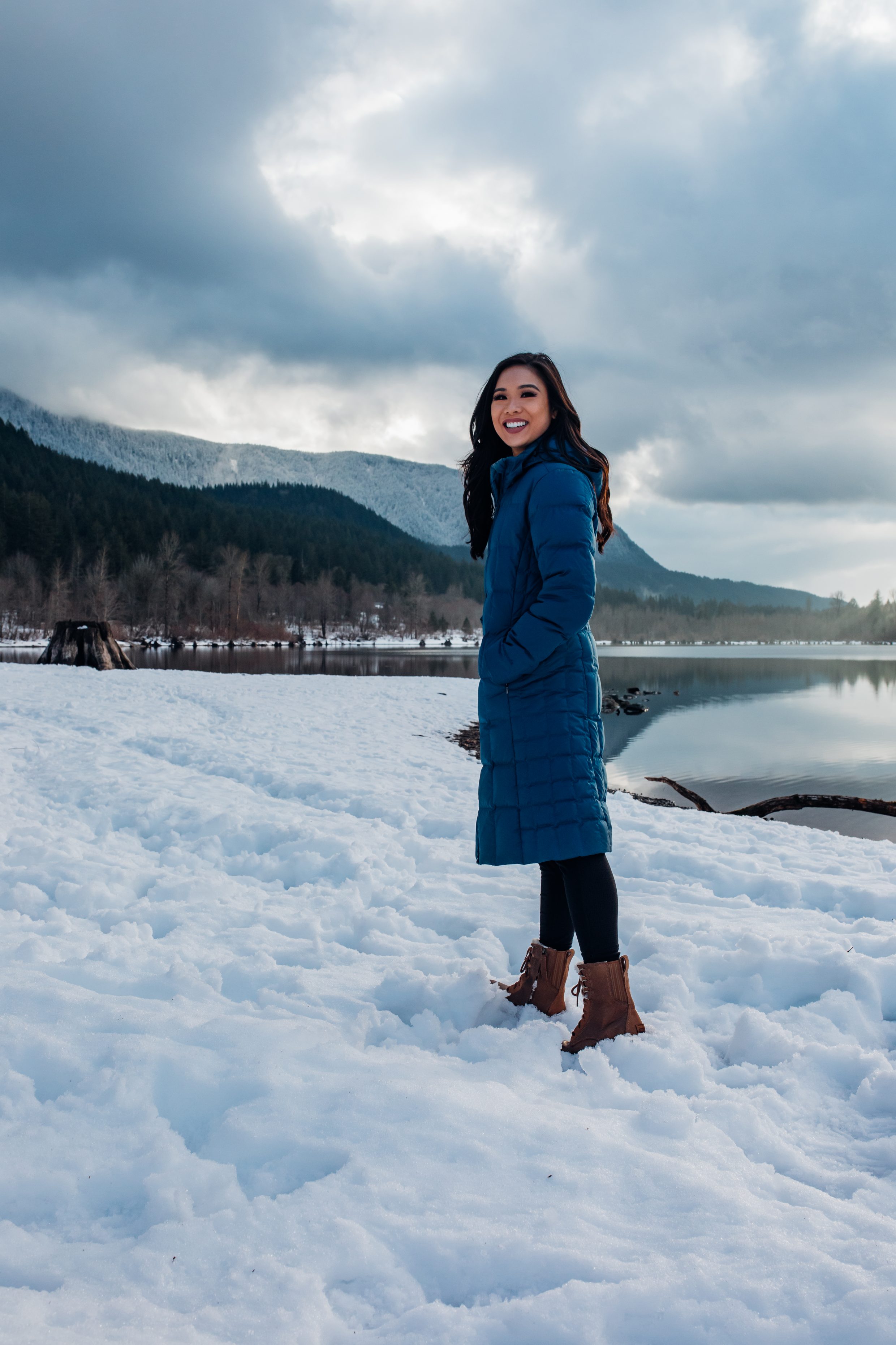 Hoang-Kim explores Rattlesnake Lake during winter wearing a blue Patagonia parka