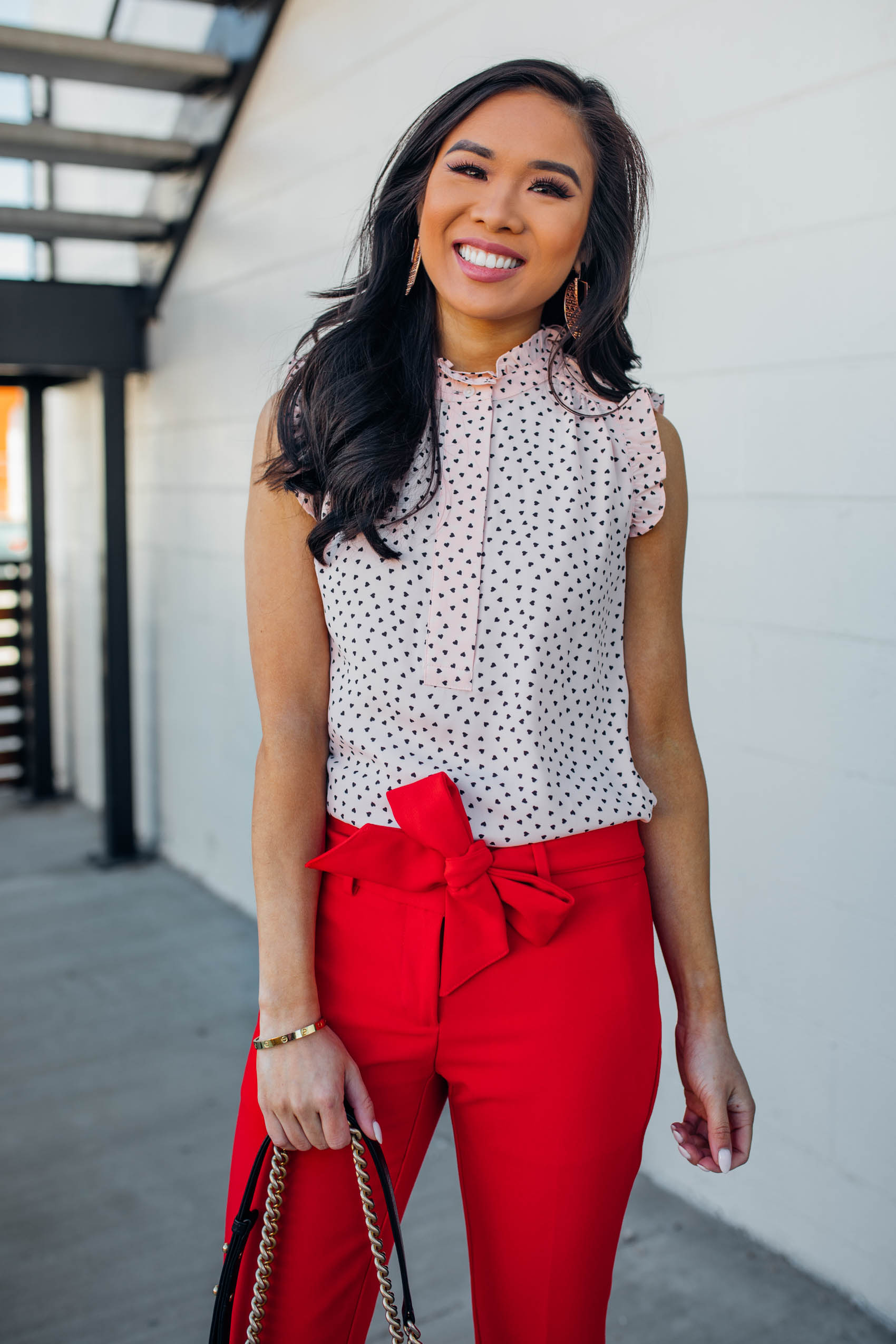 Blogger Hoang-Kim wears a pair of red tie-waist pants for a work outfit