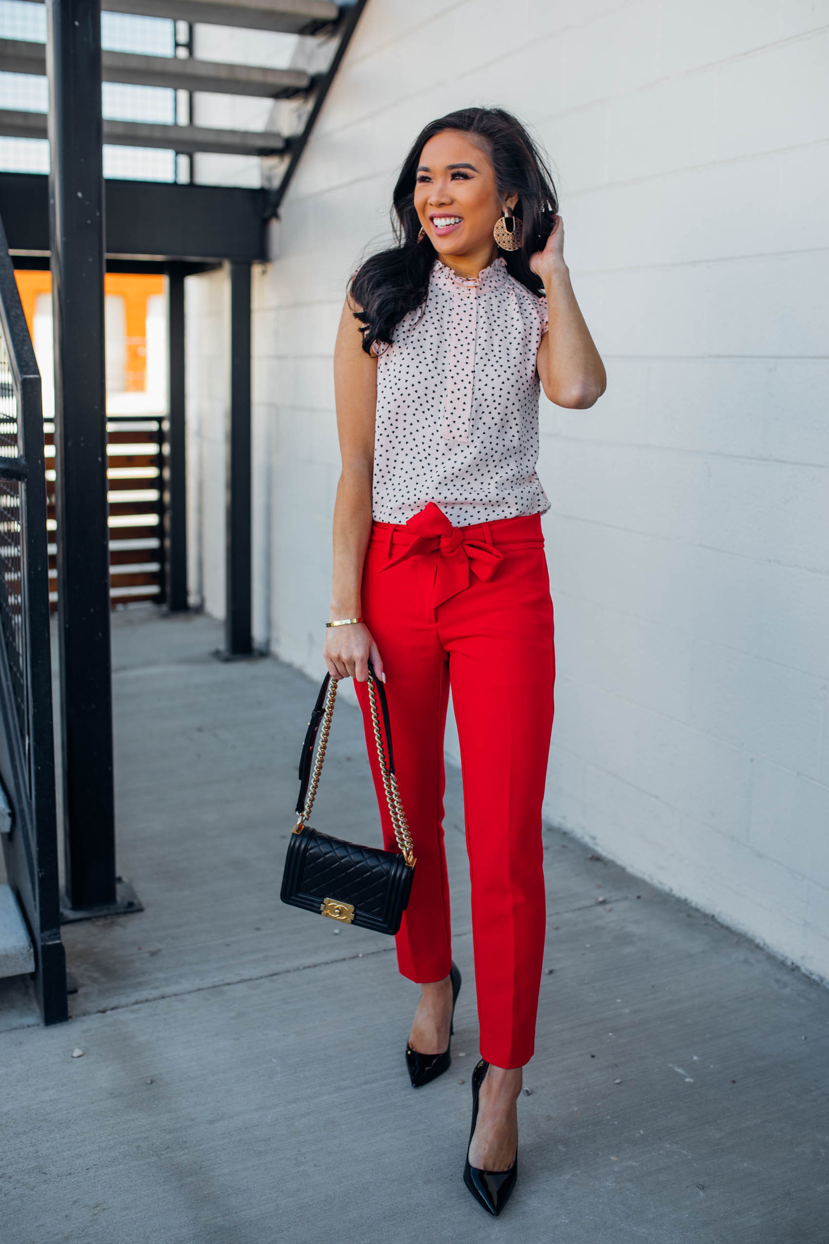 Blogger Hoang-Kim wears a pair of red tie-waist pants for a work outfit