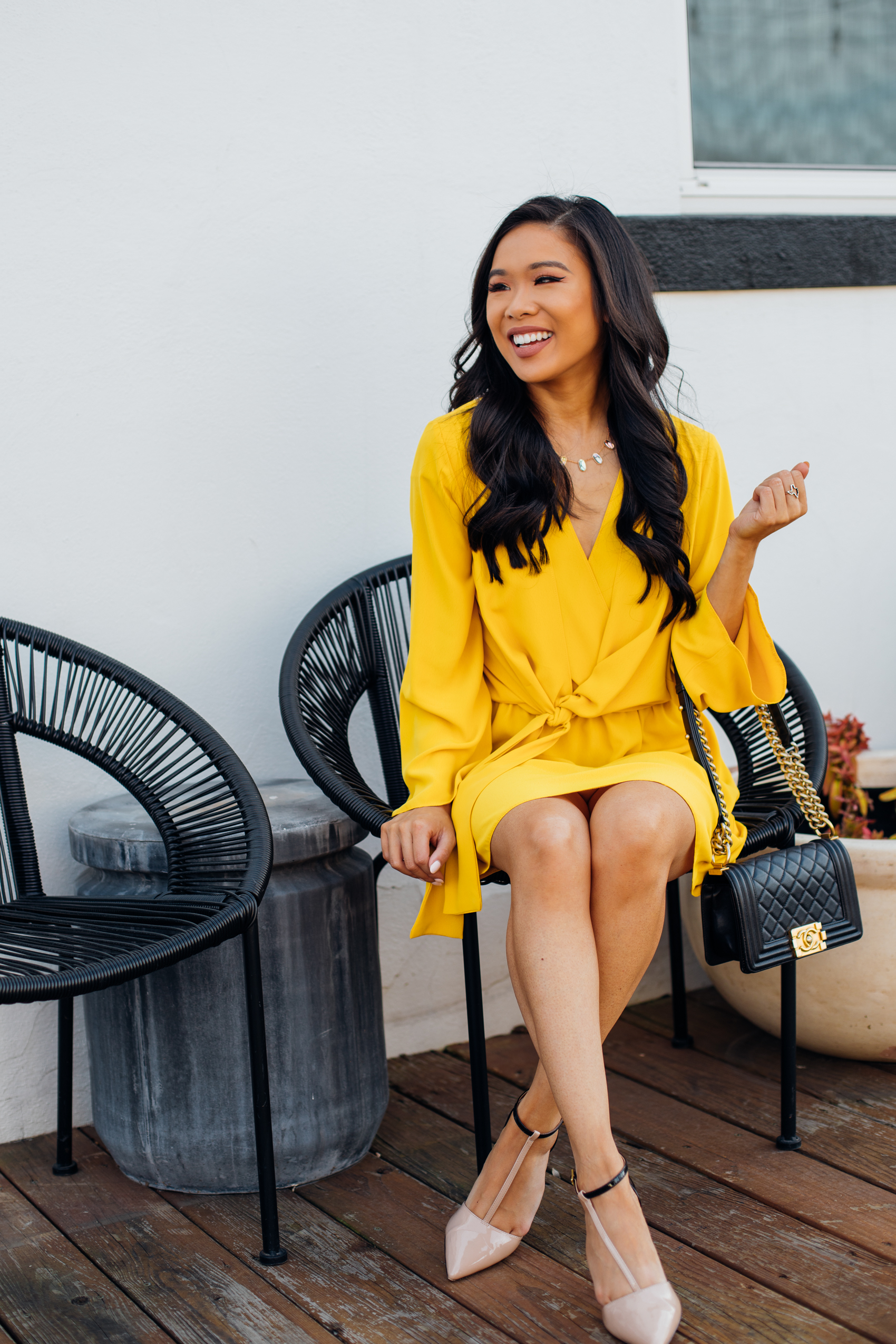 Blogger Hoang-Kim wears a yellow Topshop knot dress with Kendra Scott earrings