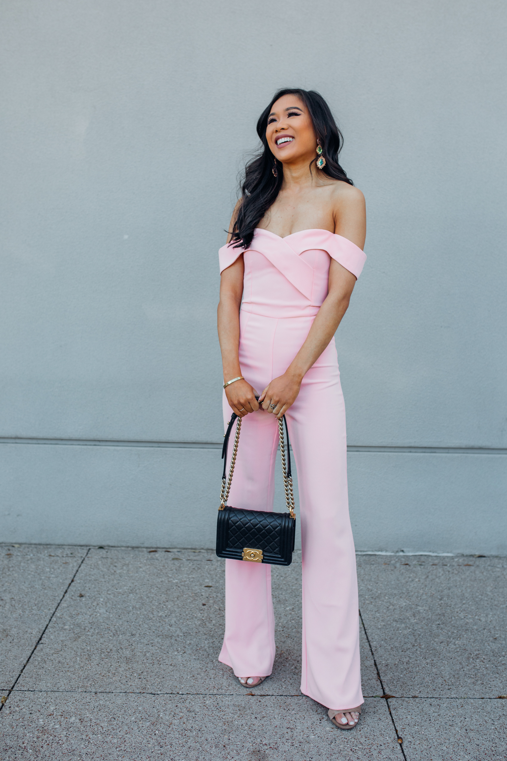 A blush off the shoulder jumpsuit you can wear as a wedding guest