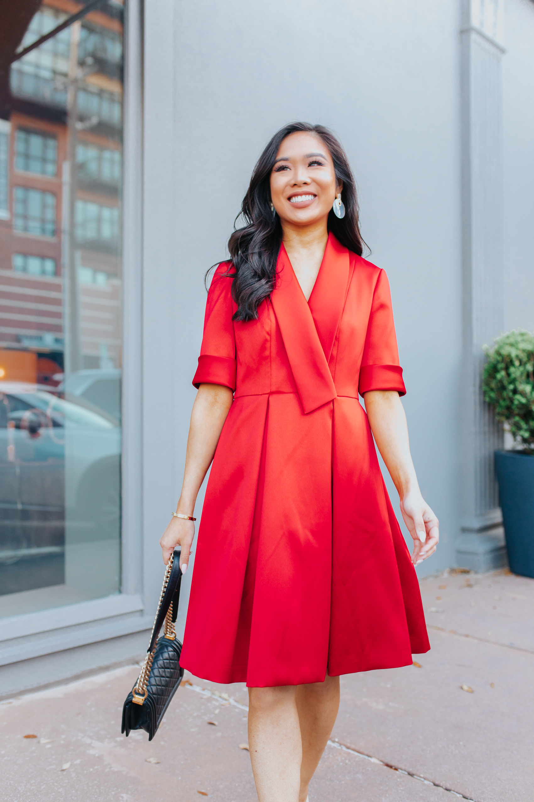 Asian woman wearing a red dress with an oversized lapel