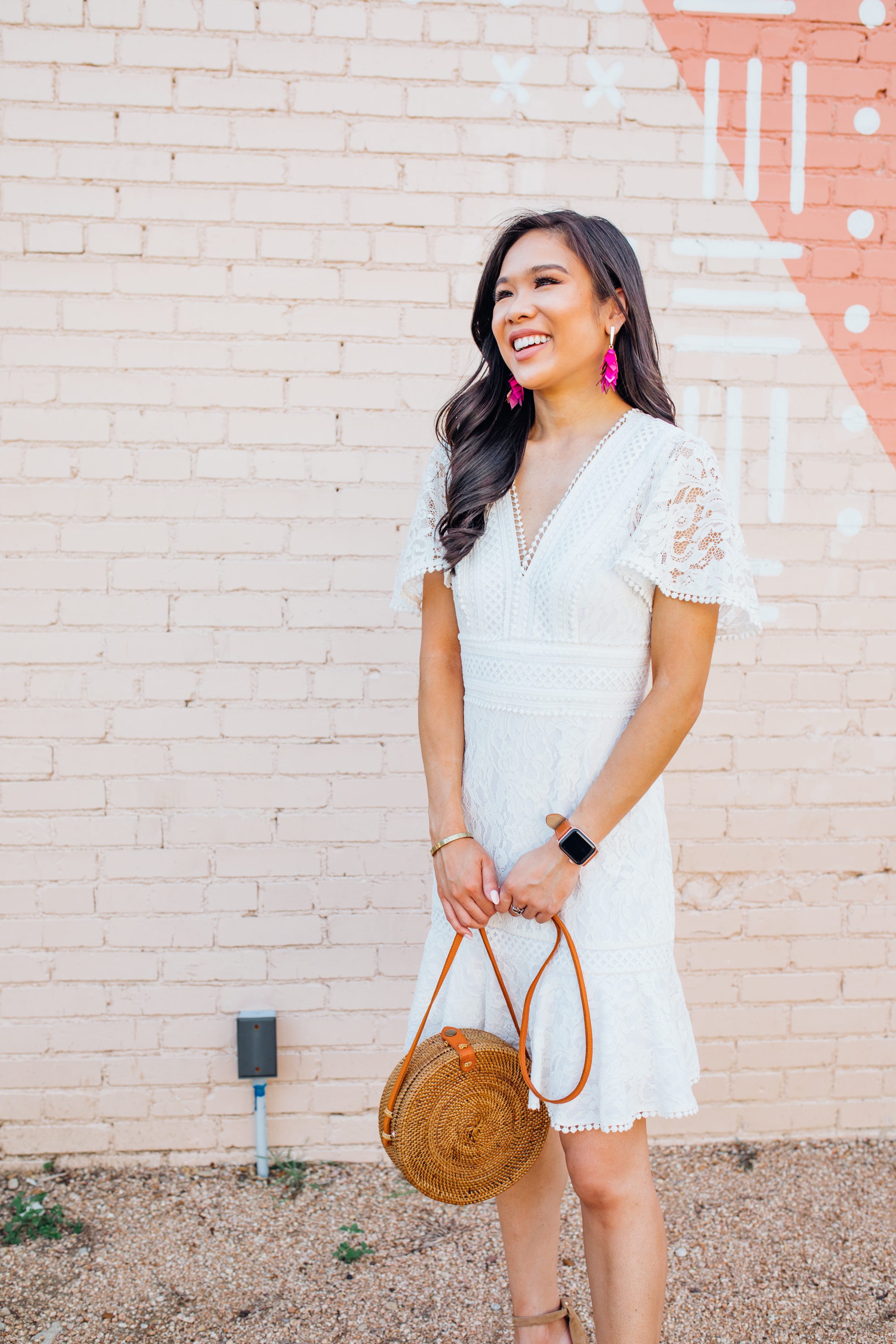 Blogger Hoang-Kim wears Kendra Scott Jennifer earrings in pink mix with a white lace dress