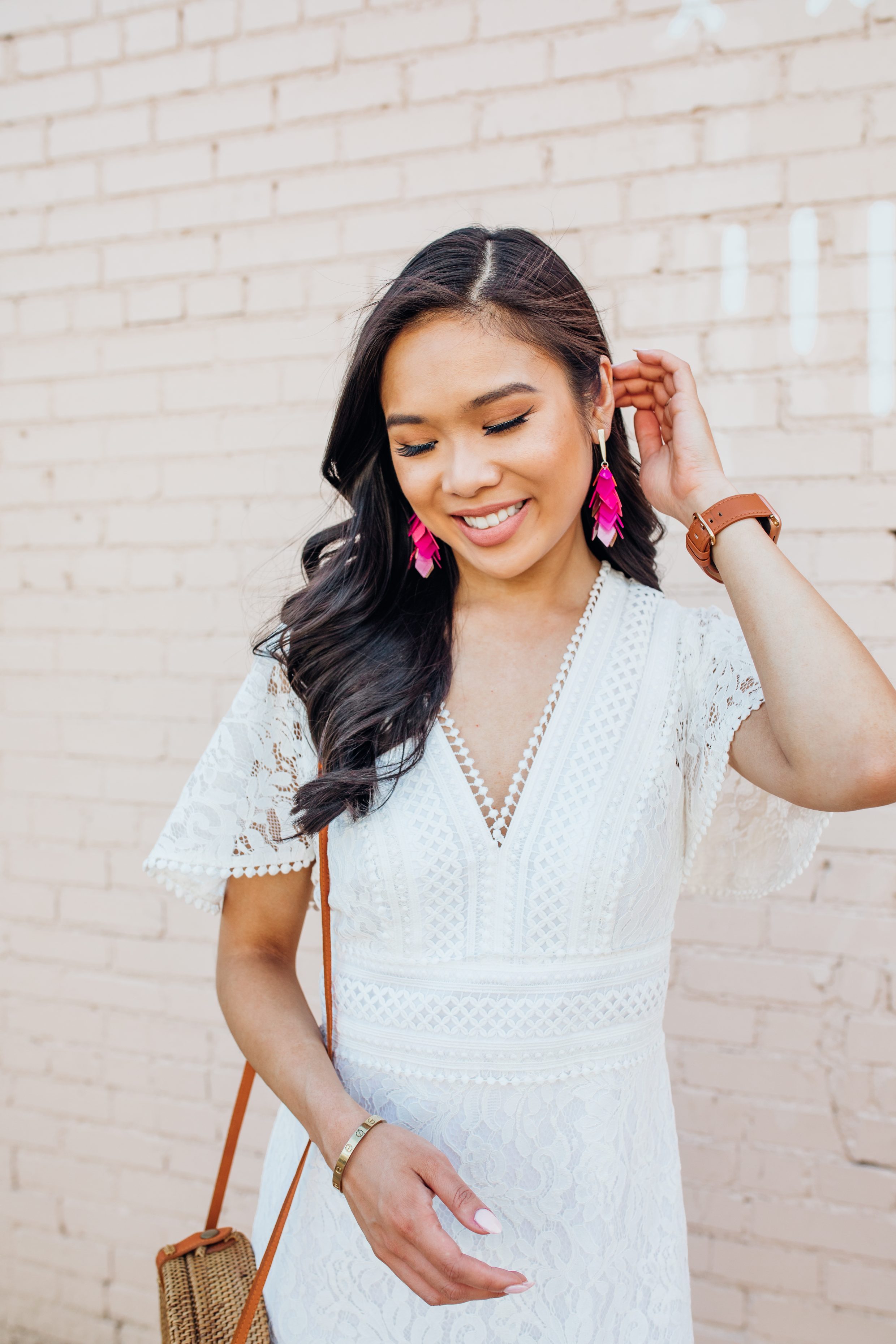 Blogger Hoang-Kim wears Kendra Scott Jennifer earrings in pink mix with a white lace dress
