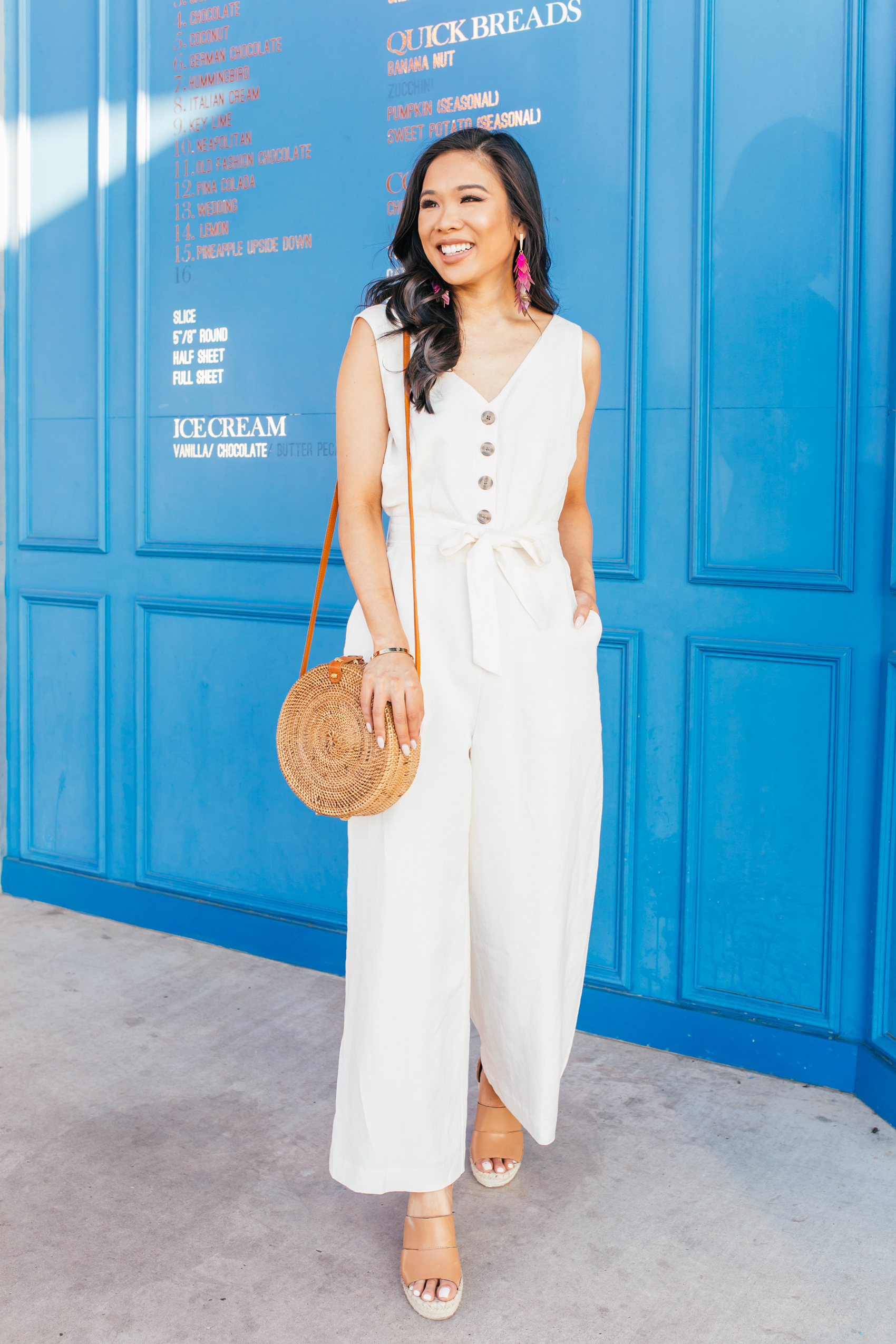 Linen jumpsuit with rattan bag for a summer outfit