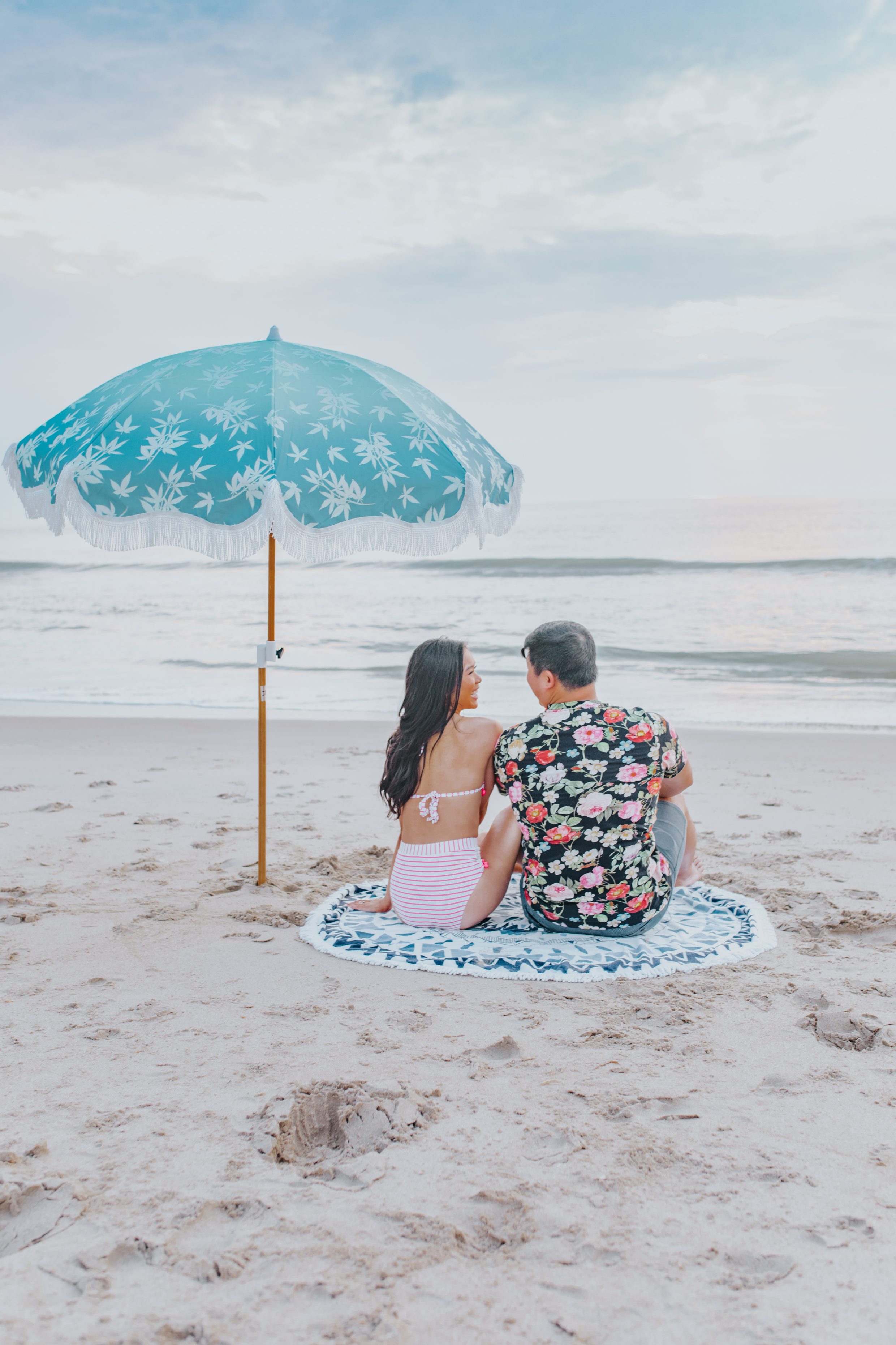 Blogger Hoang-Kim and her boyfriend Jonathan Van at the Virginia Beach Oceanfront with a beach umbrella and round towel
