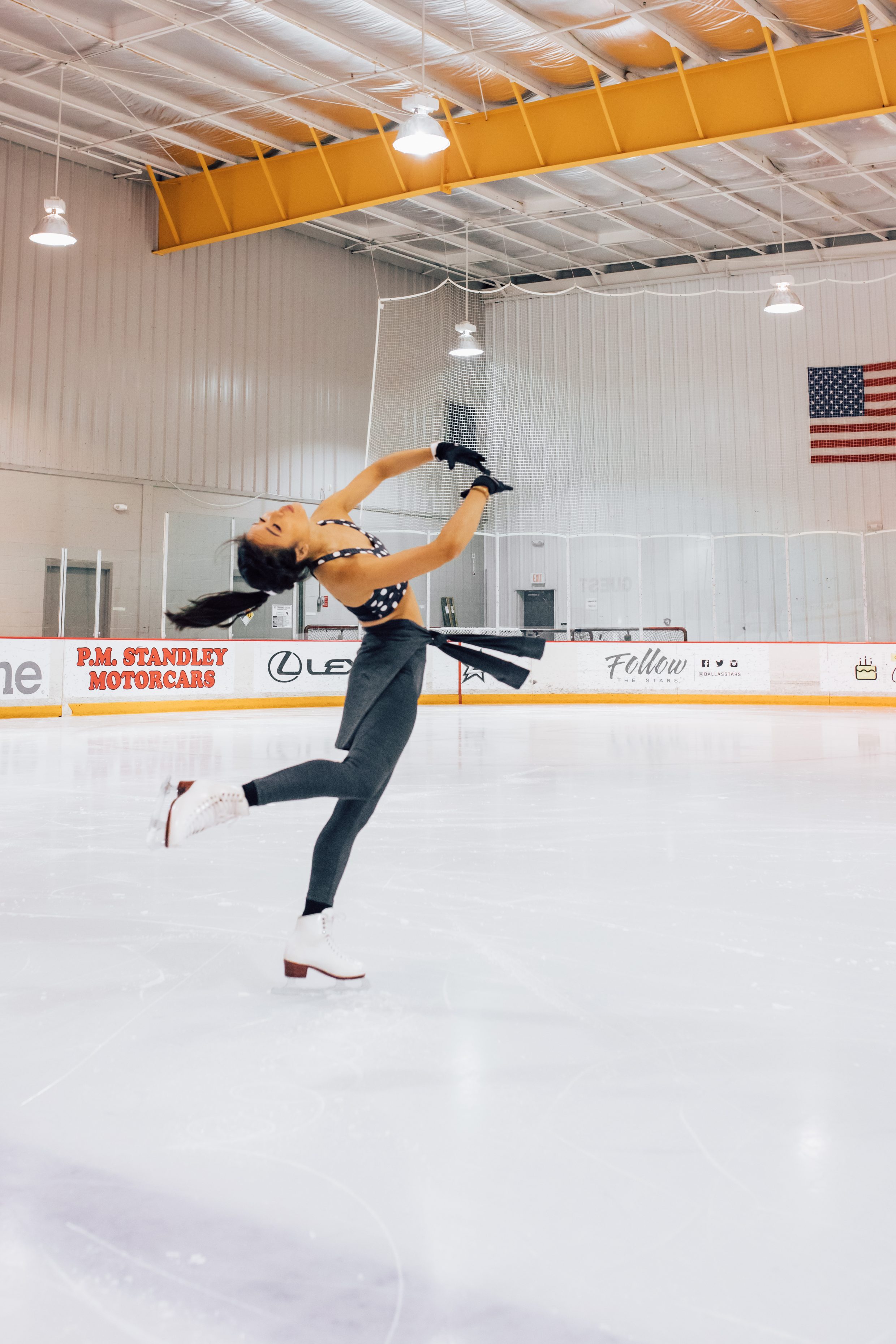 Figure skater does a layback spin at a Dallas ice rink