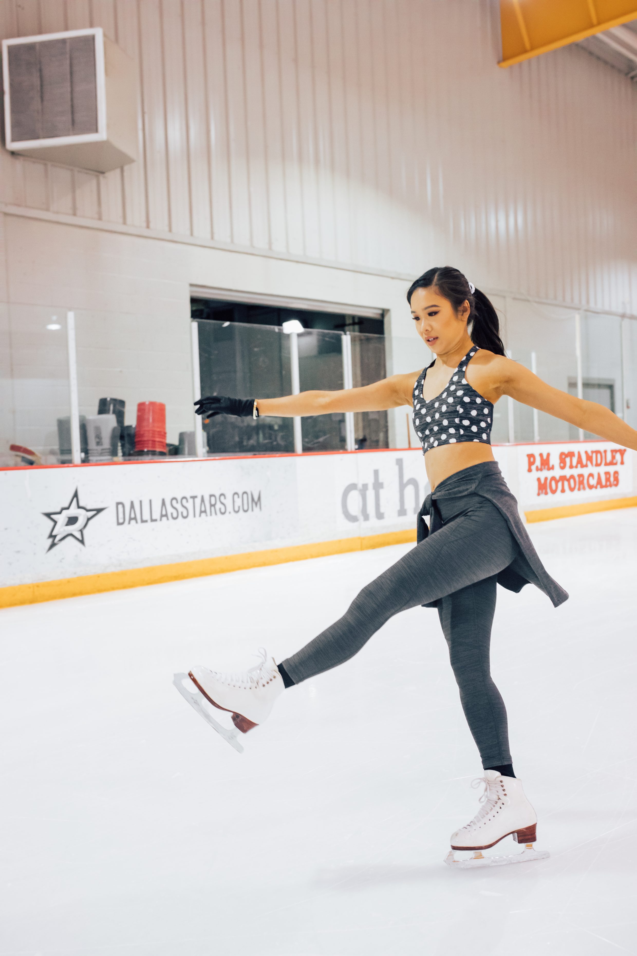 Figure skater wearing polka dot activewear at a Dallas Ice skating rink