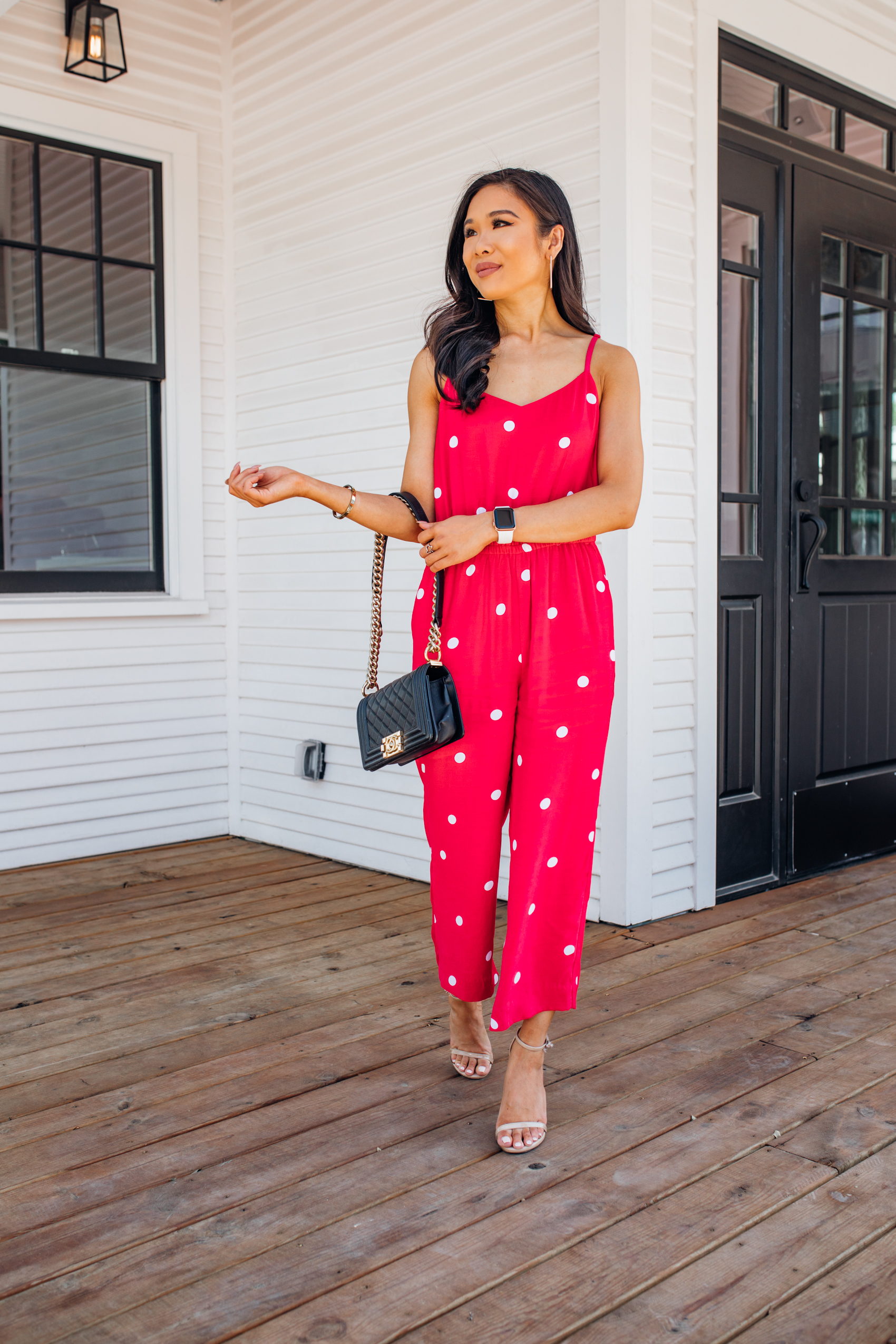 Petite blogger wearing a red polka dot jumpsuit with pockets and Kendra Scott earrings in Bishop Arts Dallas