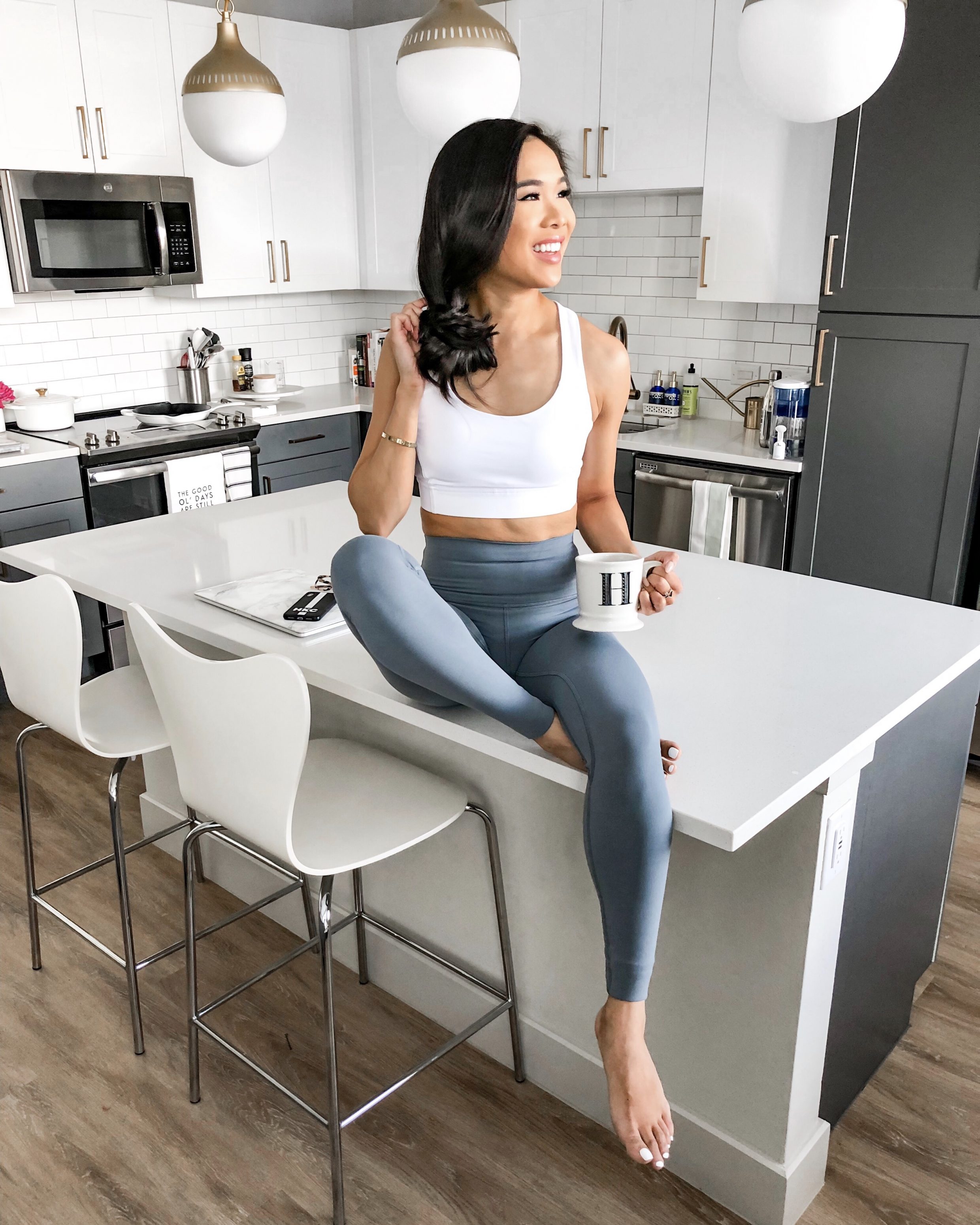 Blogger Hoang-Kim wears a lululemon athletica energy sports bra and align high-waisted leggings in her Dallas apartment