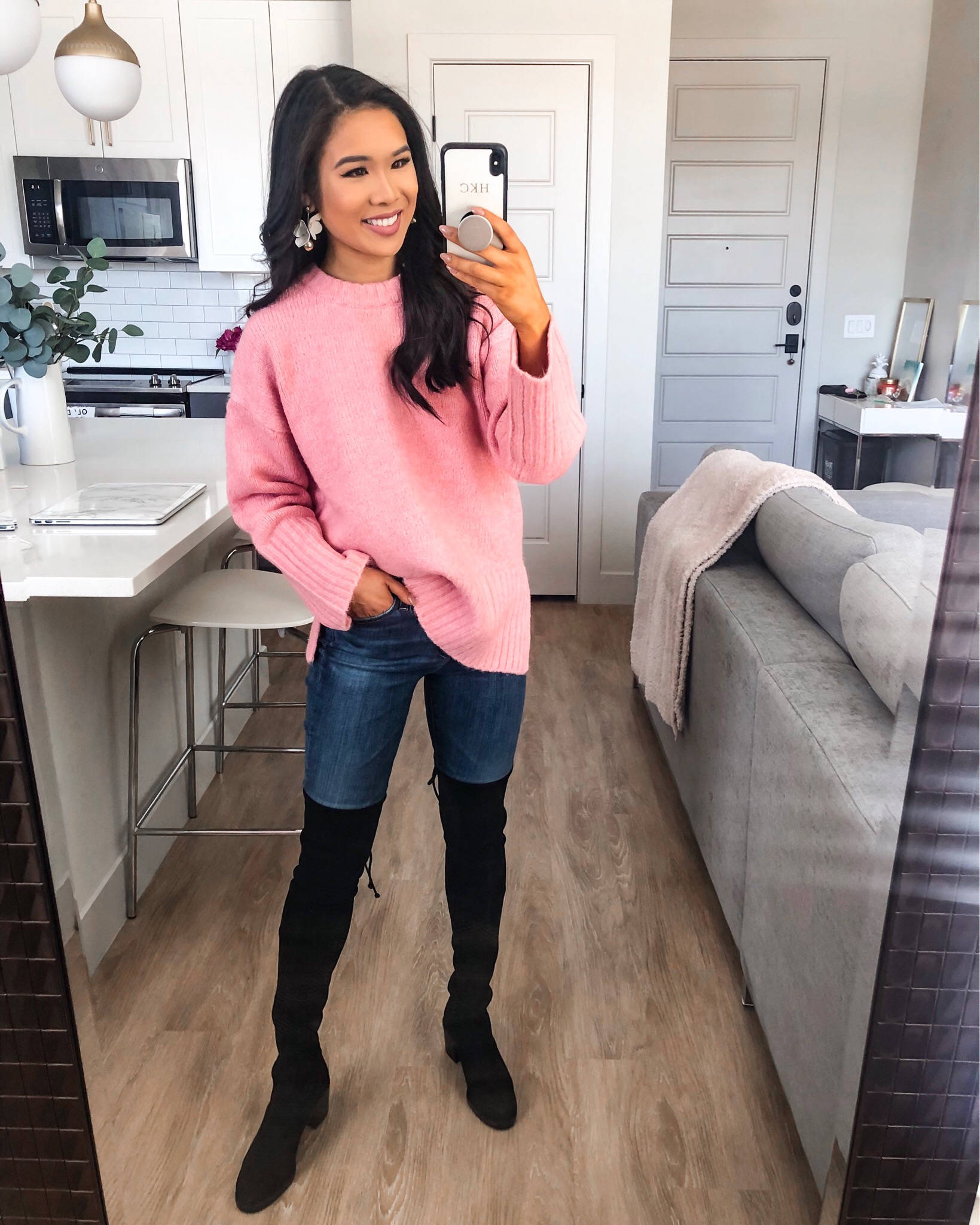 Blogger Hoang-Kim wears a Topshop pullover sweater, AG Jeans and Stuart Weitzman Darla Over the Knee Boots from the Nordstrom Sale