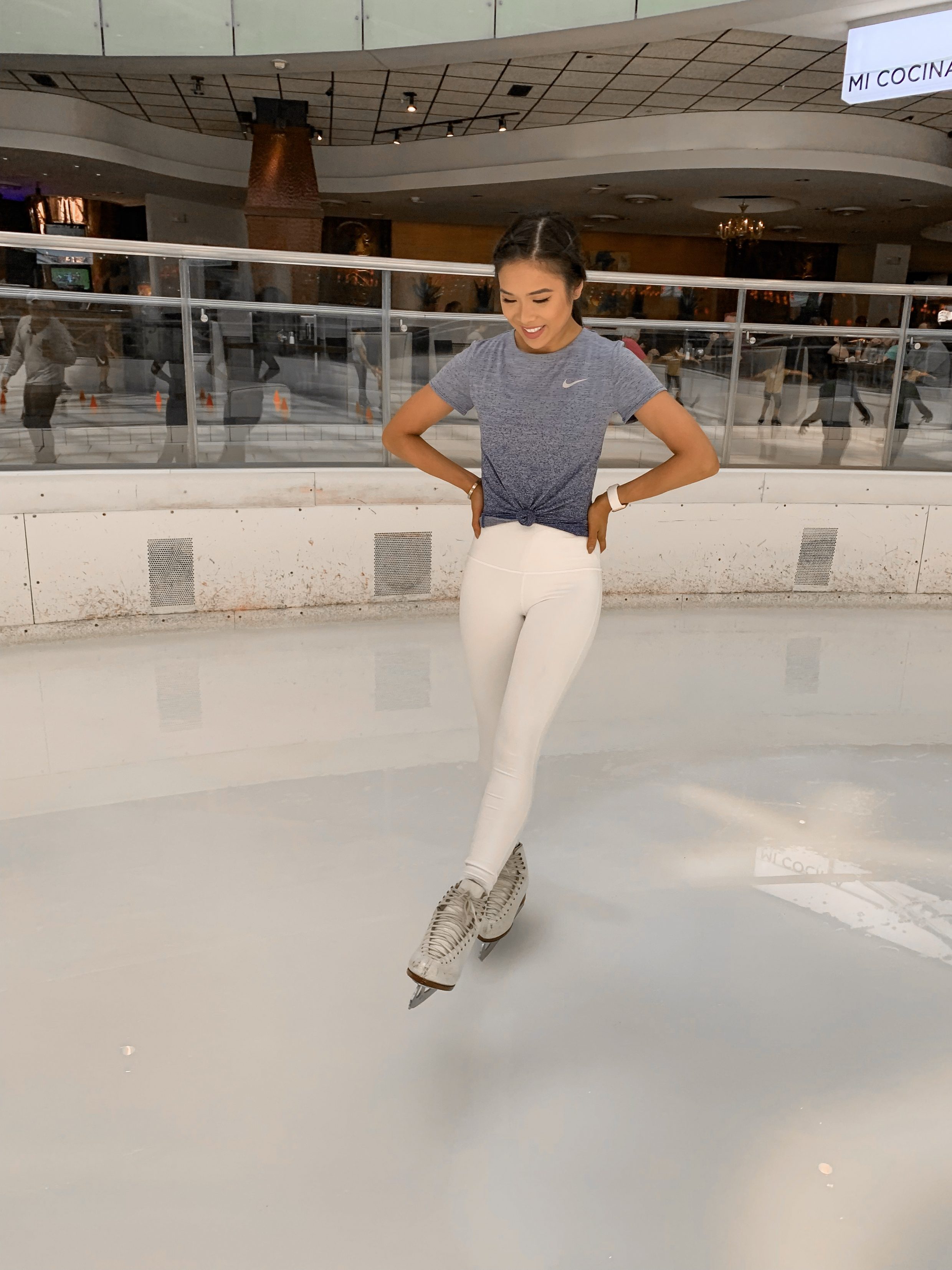 Ice skating outfit featuring blue dri-fit shirt and white high waisted leggings