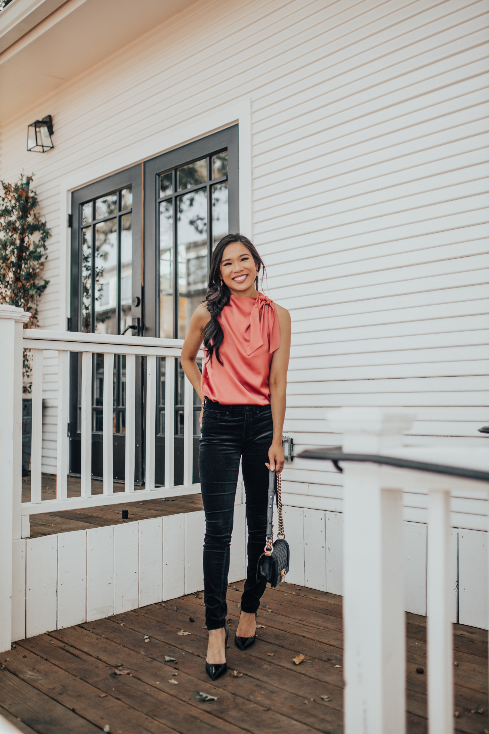 Fall outfits with black velvet skinny pants and satin top with a messy braid