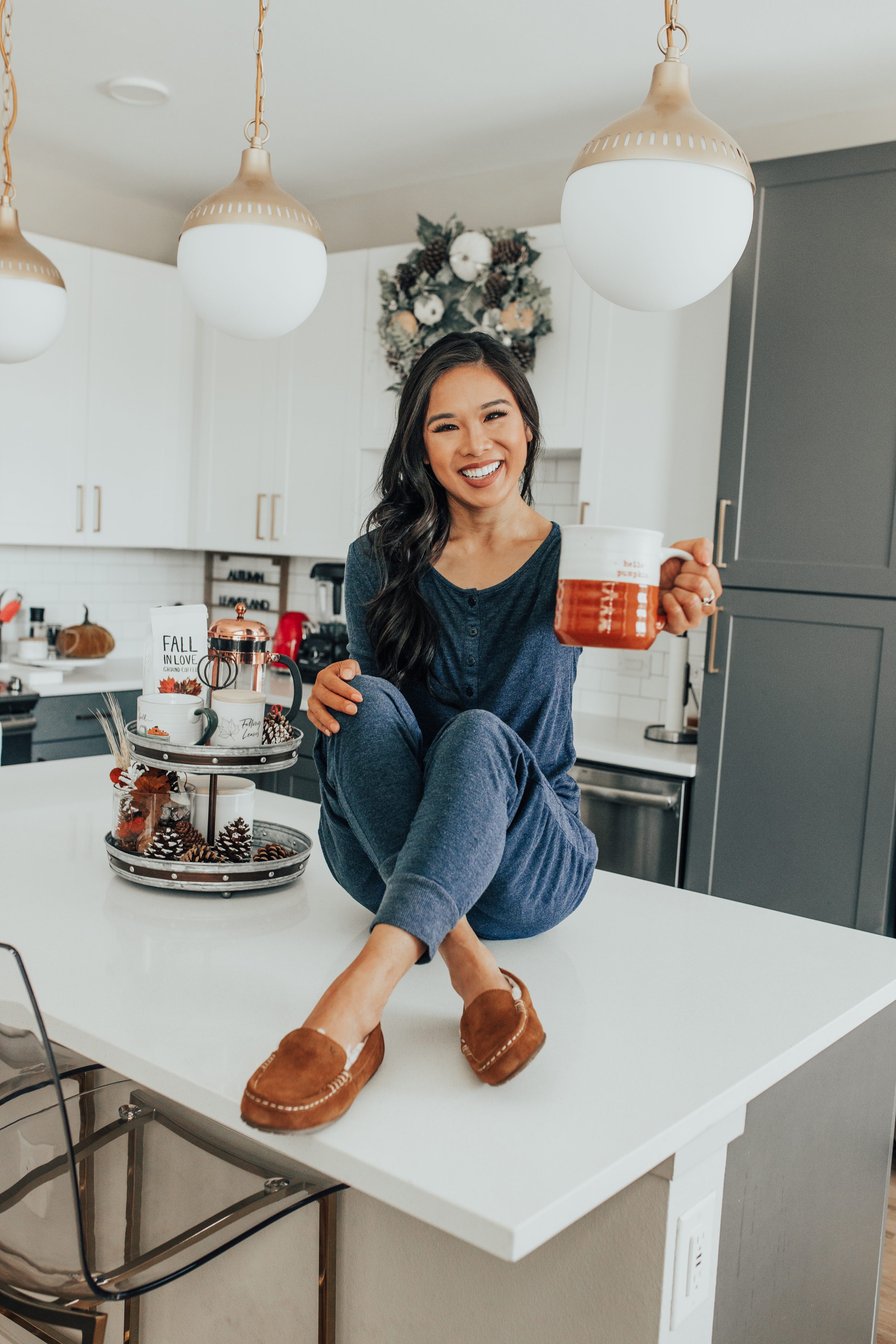 Blogger Hoang-Kim wears Tommy John loungewear set with a henley tee and jogger pants in her Dallas apartment with fall kitchen decor
