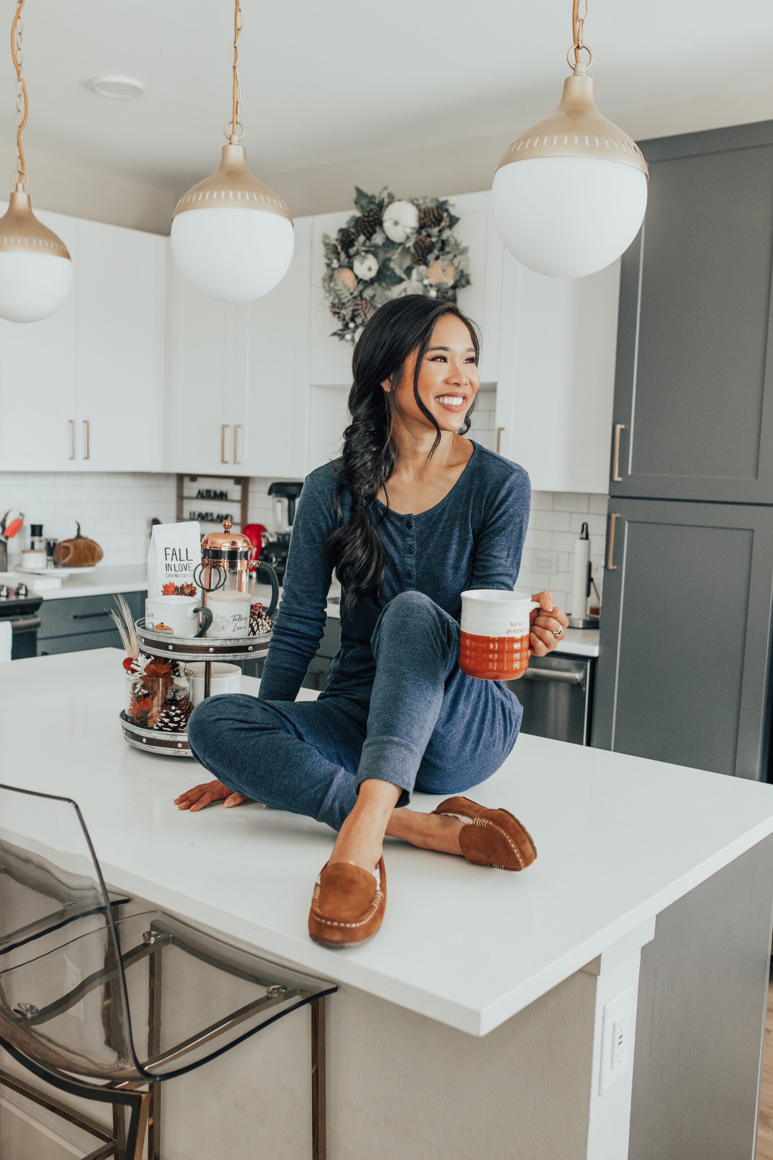 Fall kitchen decor in a white kitchen with two toned cabinets in a Dallas apartment with blogger Hoang-Kim