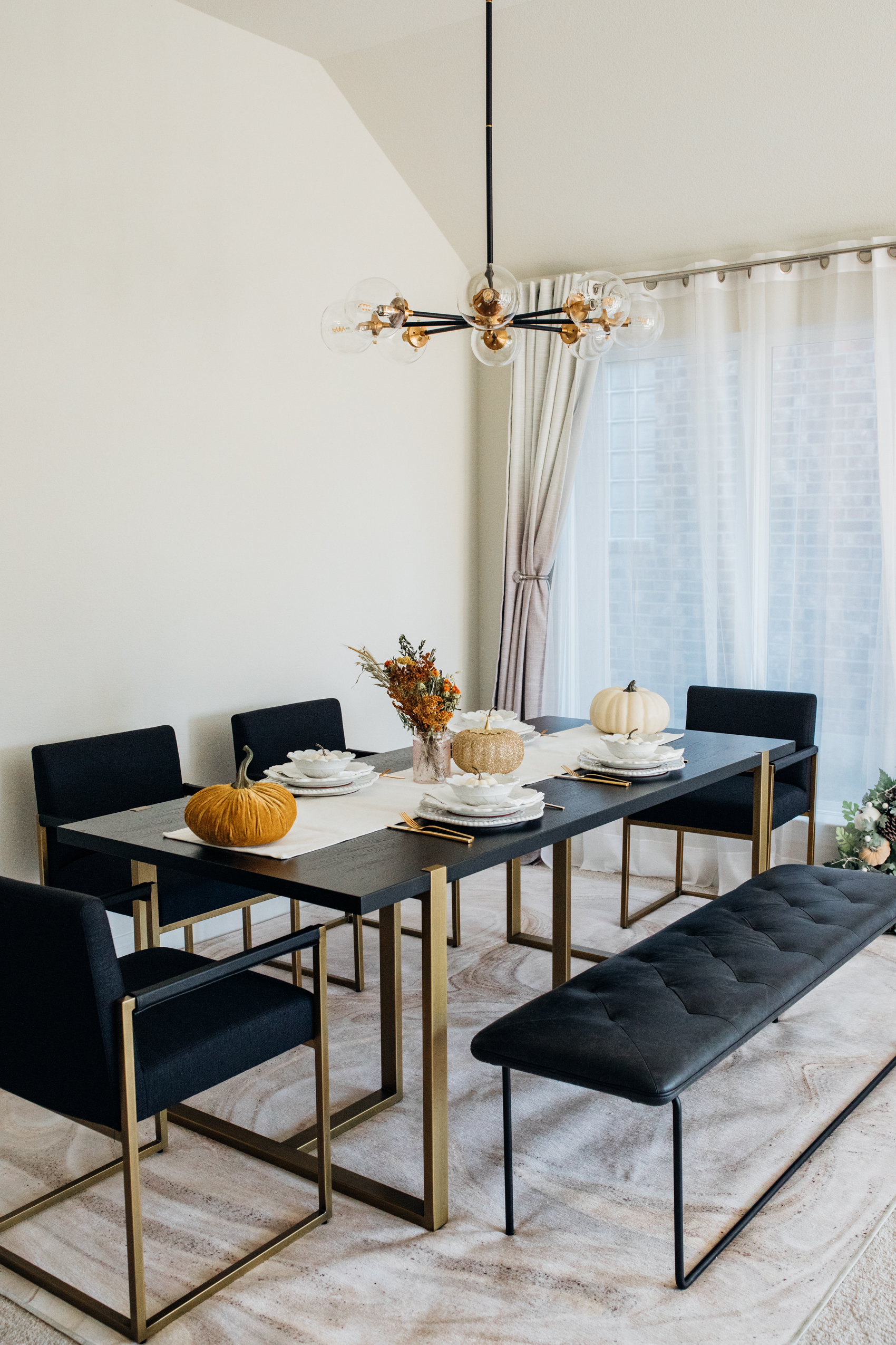 Article Oscuro dining table with gold legs in a modern dining room for Thanksgiving