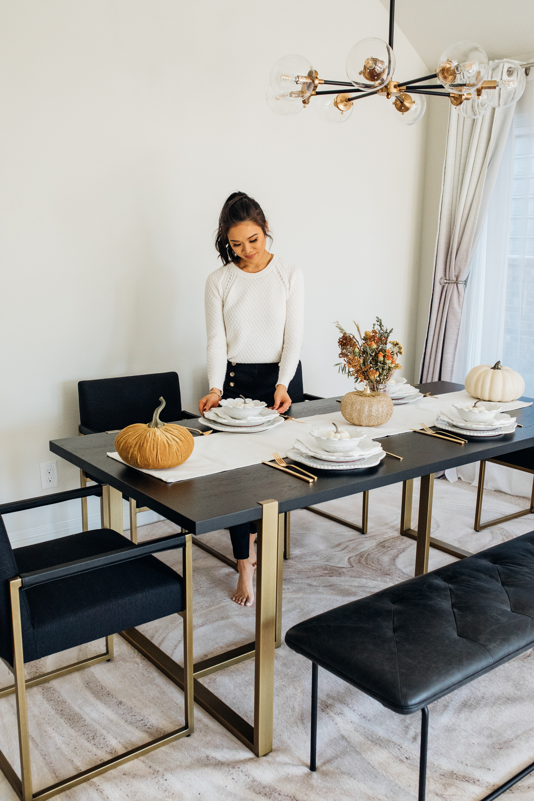 Article Oscuro dining table with gold legs in a modern dining room for Thanksgiving