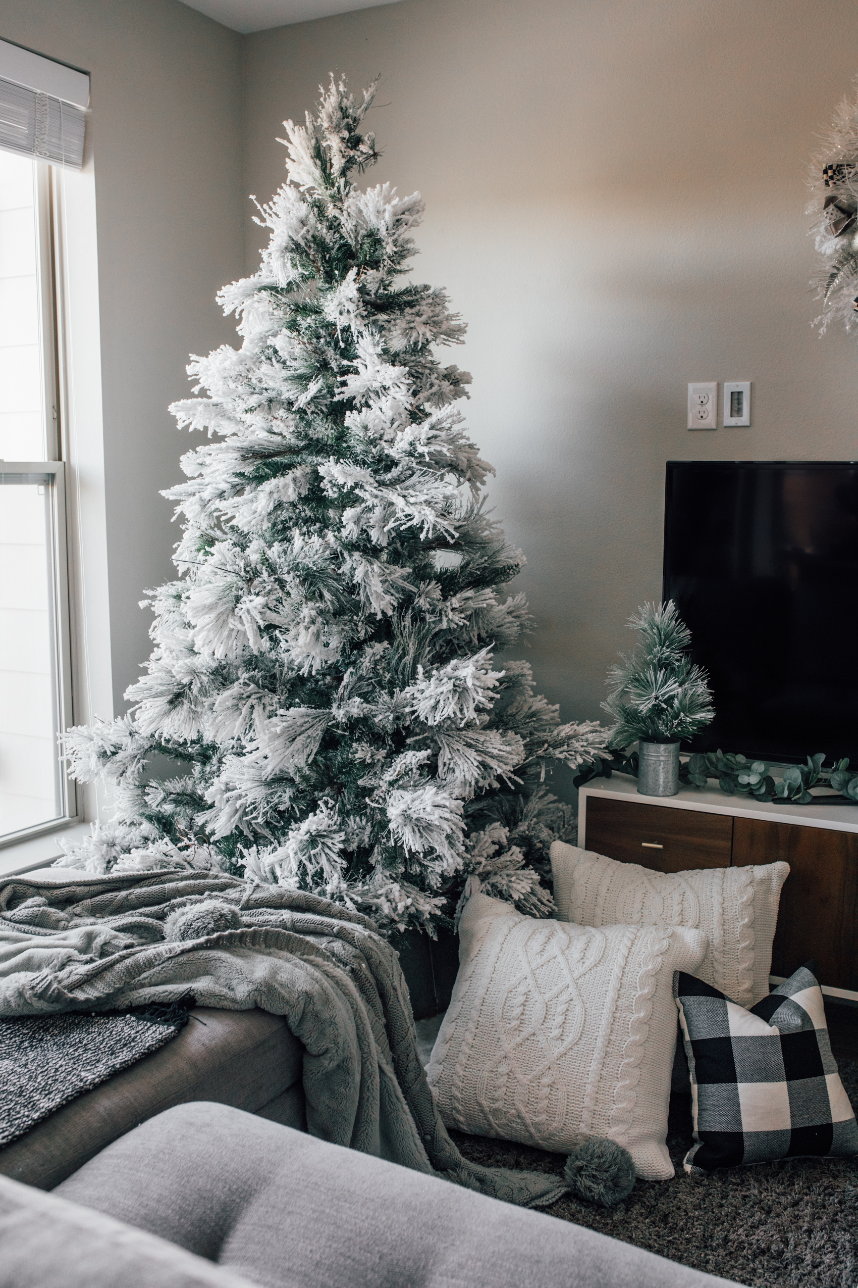 Flocked Christmas Tree decor ideas with chenille pillows, buffalo plaid and fleece