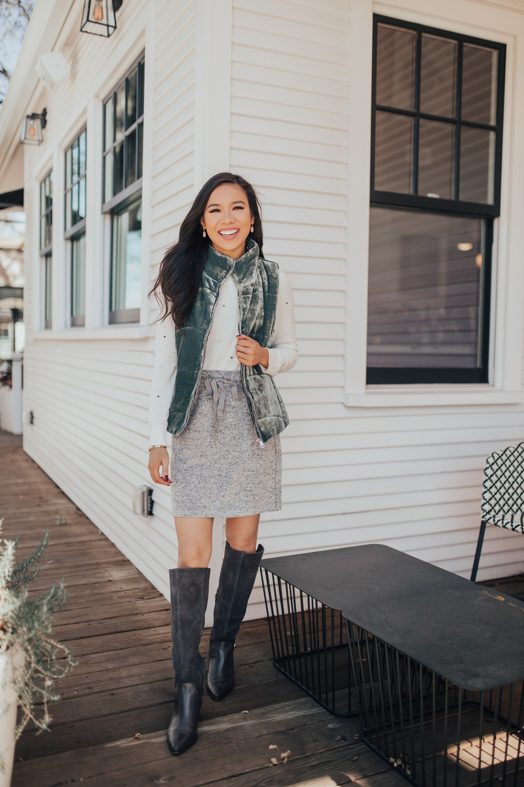 Fall outfit idea with a velvet vest, jogger skirt and knee high boots for petite ladies