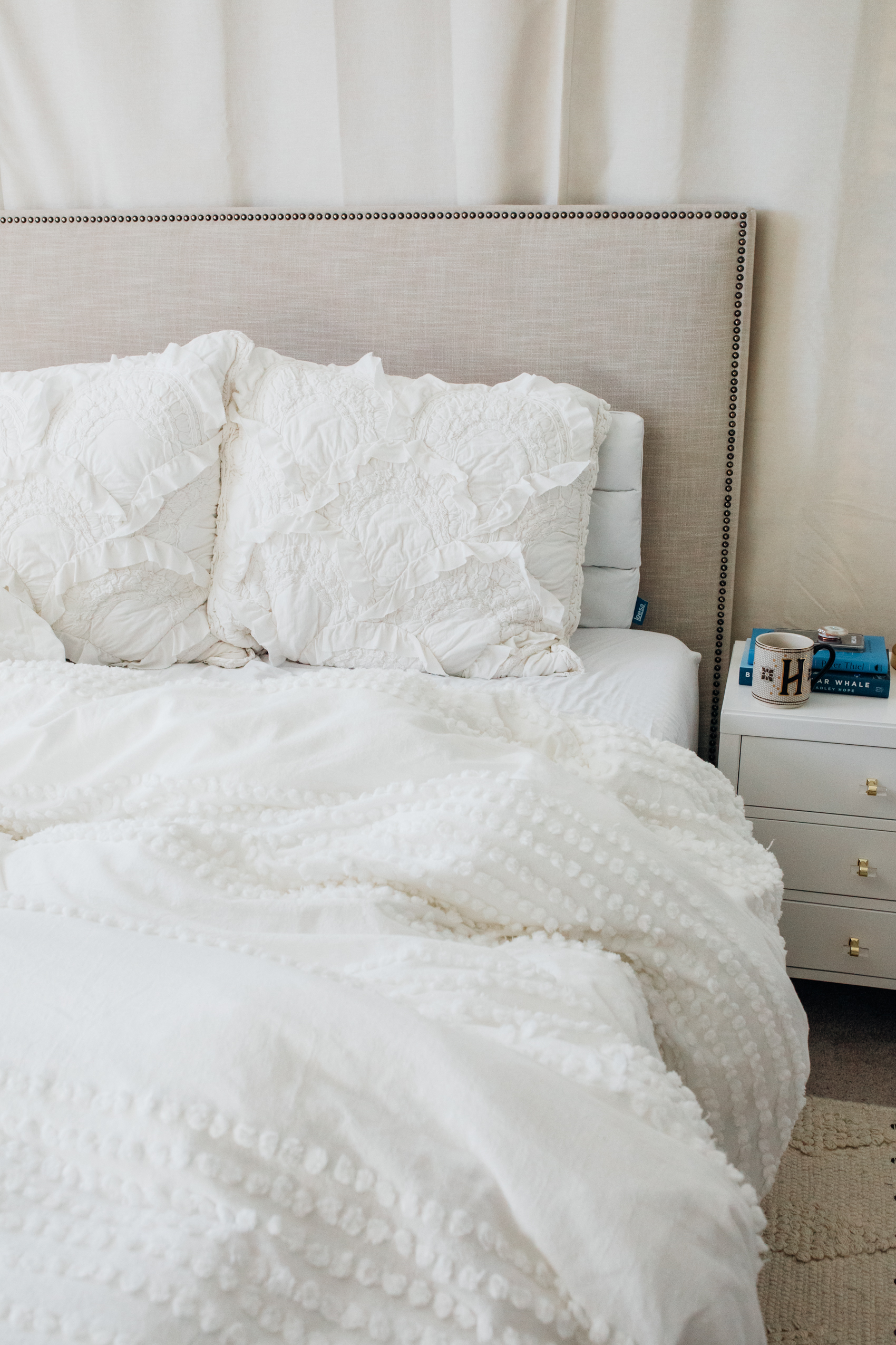 White bedding in the master bedroom with Anthropologie rivulets and west elm candlewick duvet cover