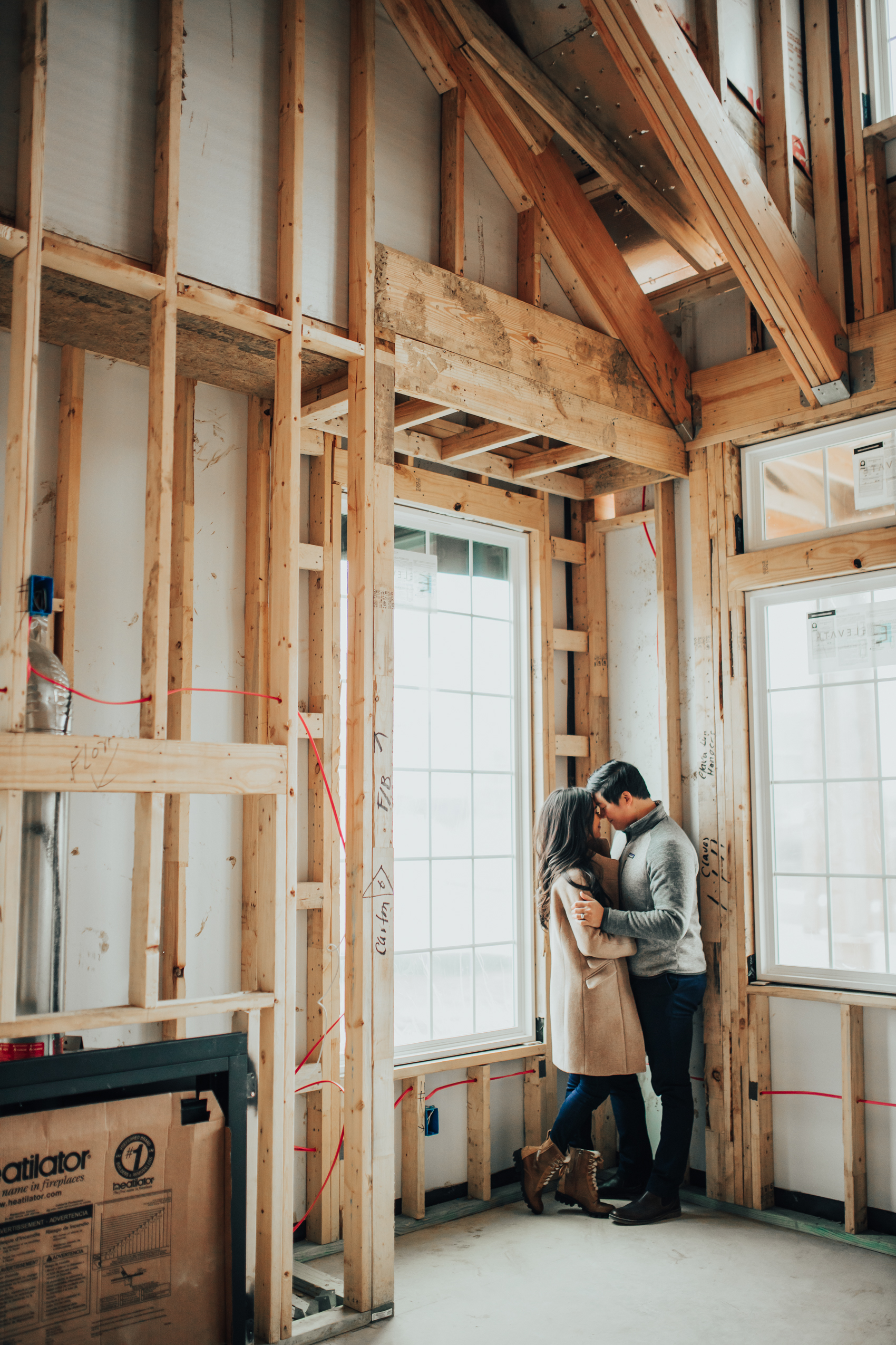 Asian couple in their new build home freshly framed before the pre-drywall meeting