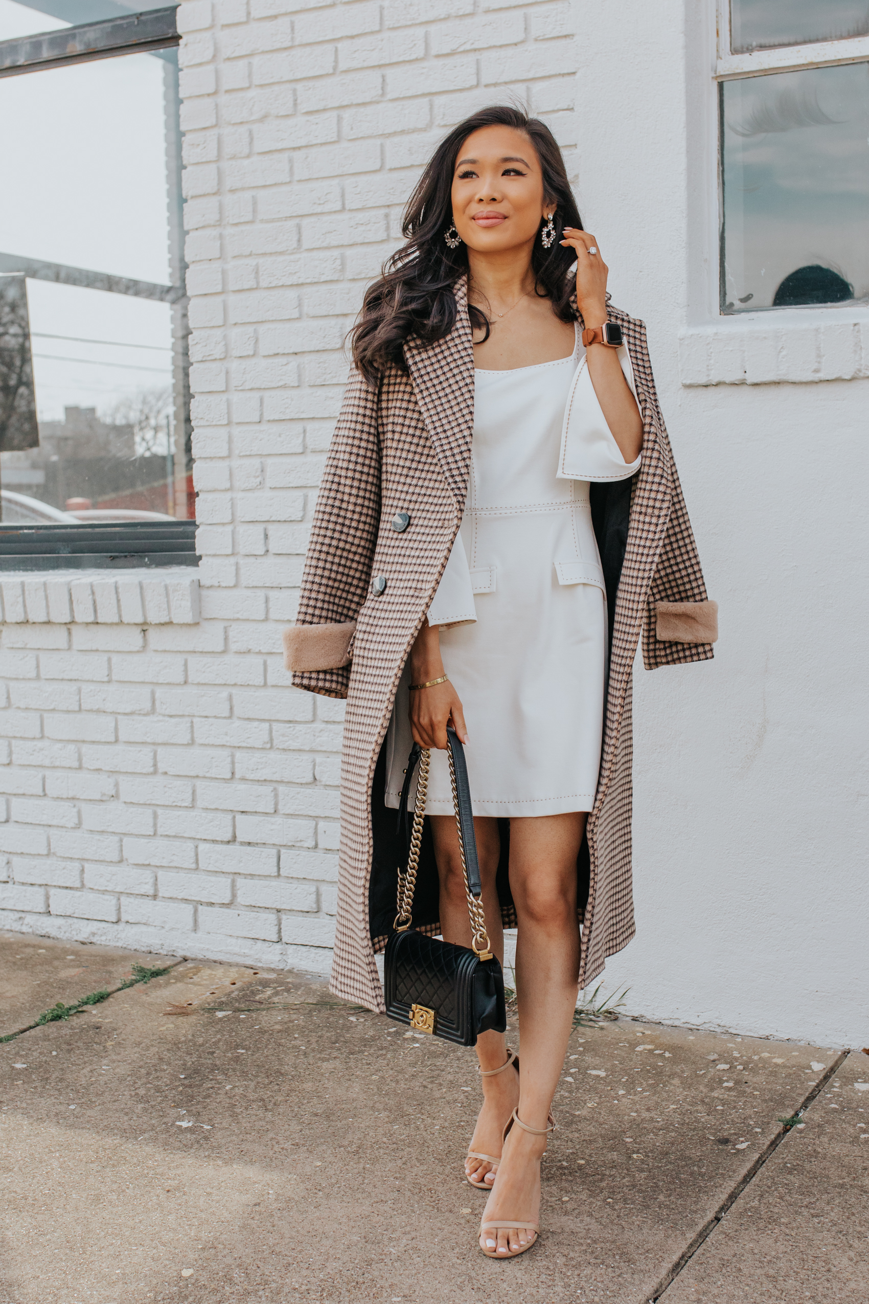 Hoang-Kim wearing a plaid coat outfit with a white dress, Chanel Boy Bag and leather apple watch band