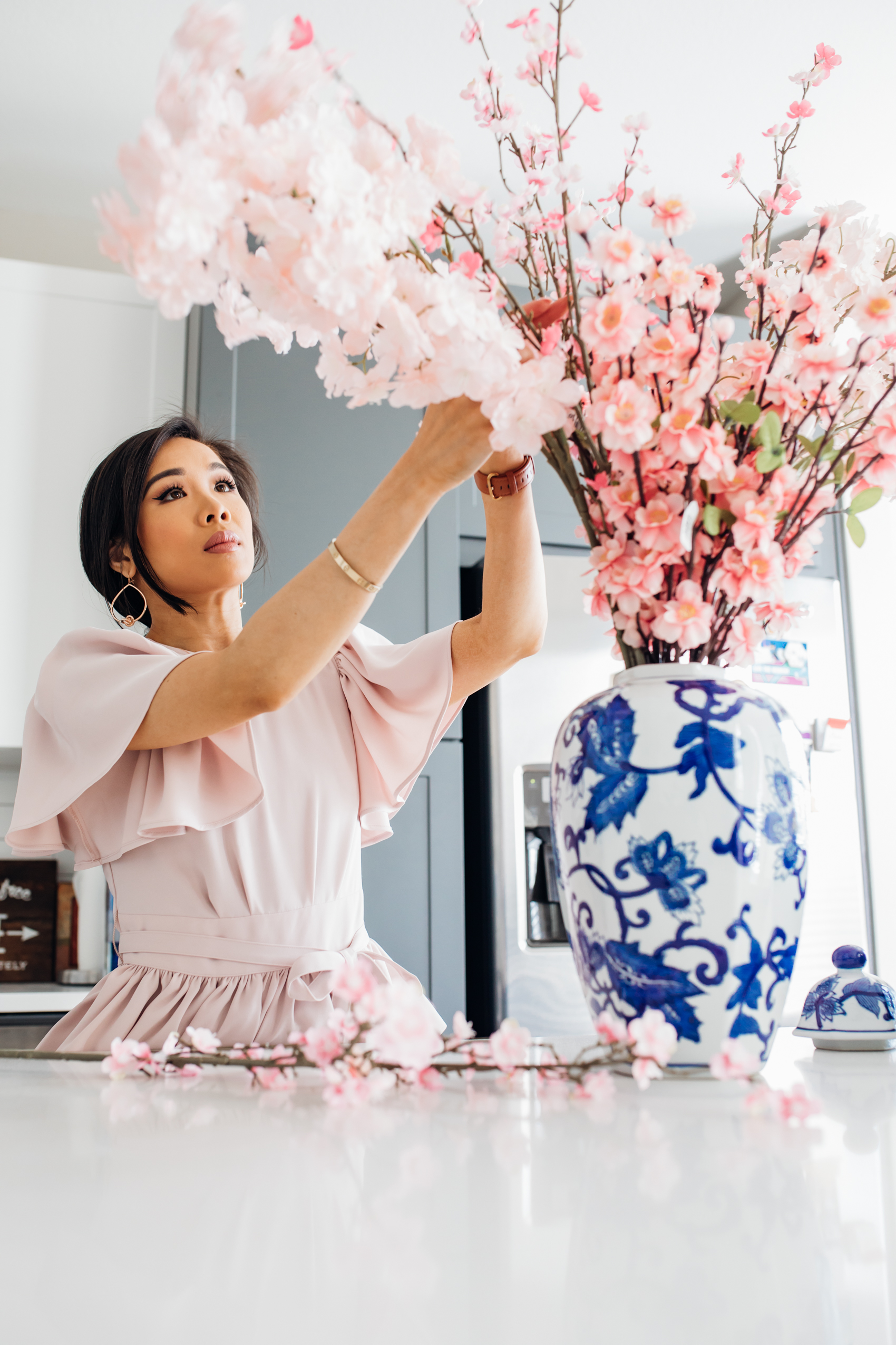 Hoang-Kim creates a faux cherry blossom and sakura arrangement using a ginger jar from At Home in her two-toned kitchen