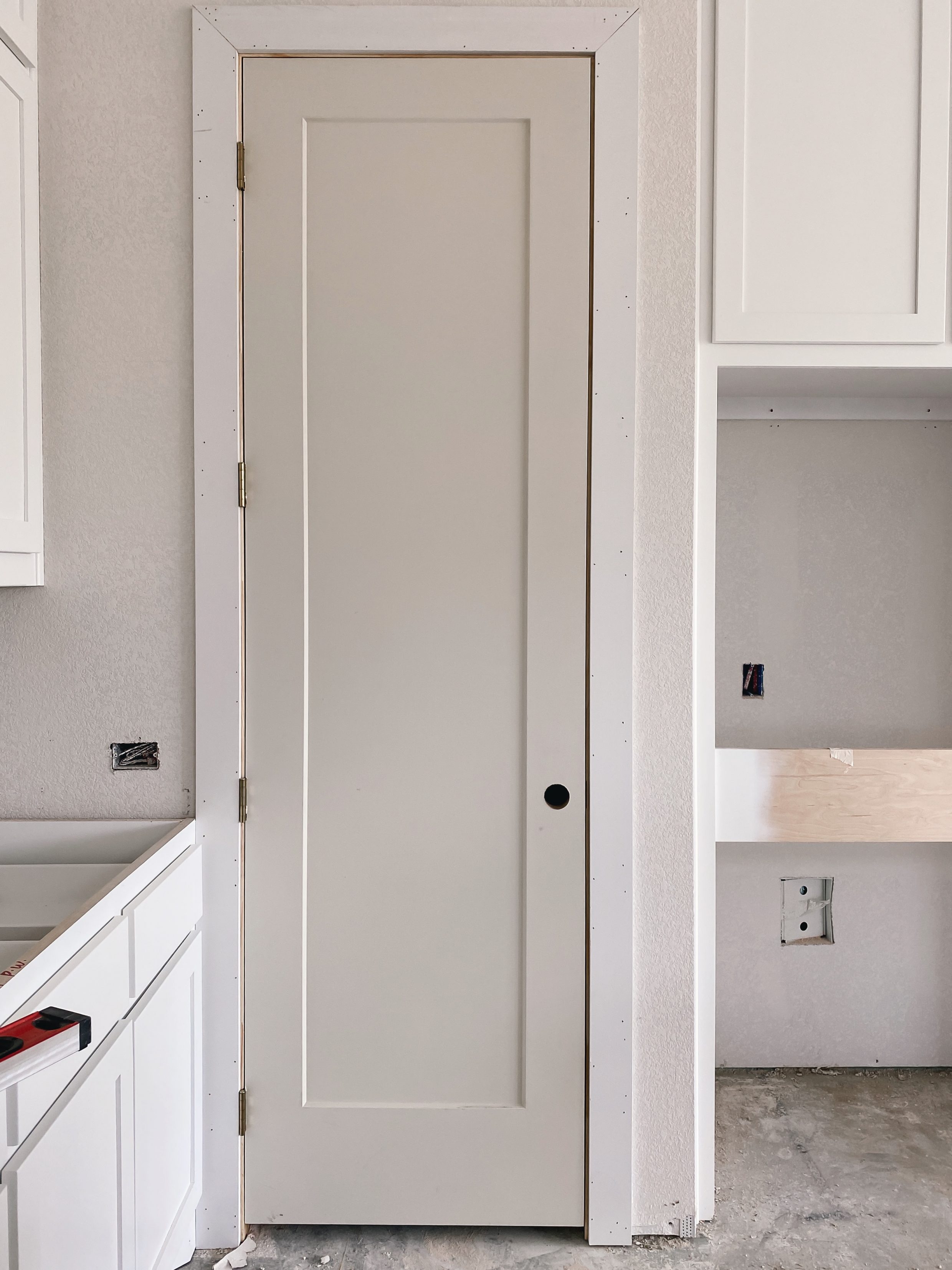 Eight feet tall shaker style pantry door in a new build home in Dallas