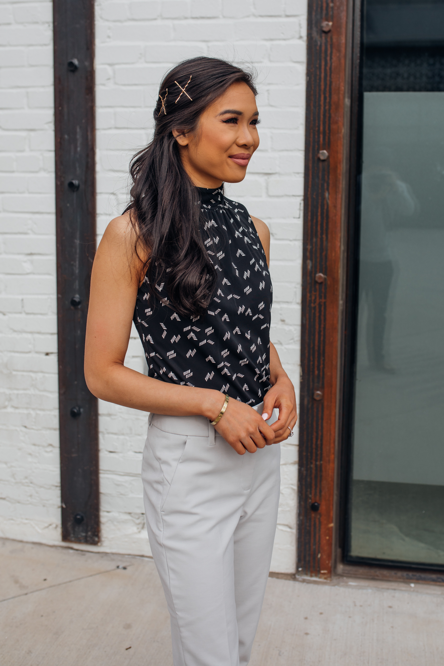 Half up half down hairstyle with gold bobby pins in an X on petite blogger Hoang-Kim wearing spring workwear from White House Black Market