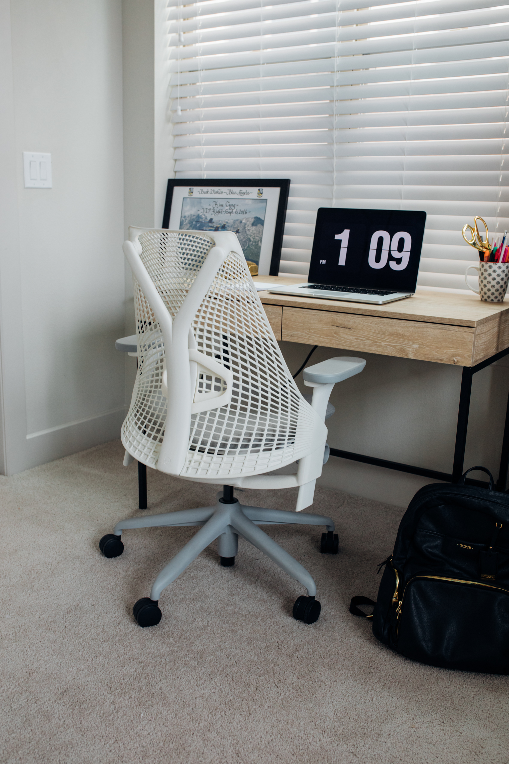 Herman Miller Sayl chair in white, writing desk, Fliqlo screensaver in Dallas Home office