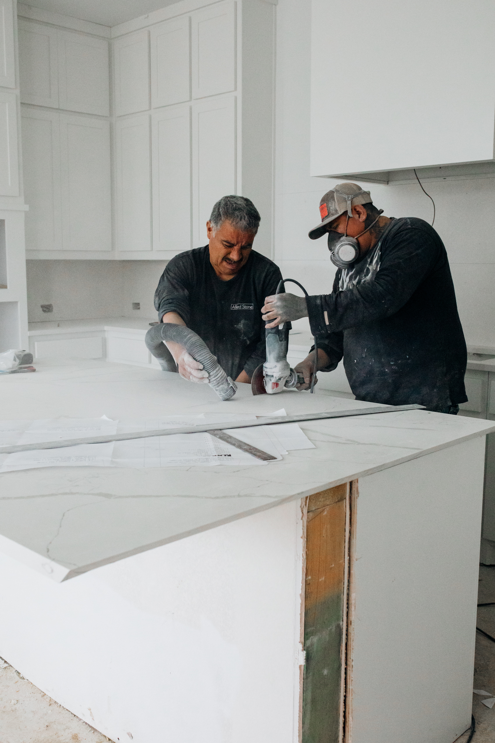 Allied Stone installing white quartz waterfall island in a Dallas home white kitchen