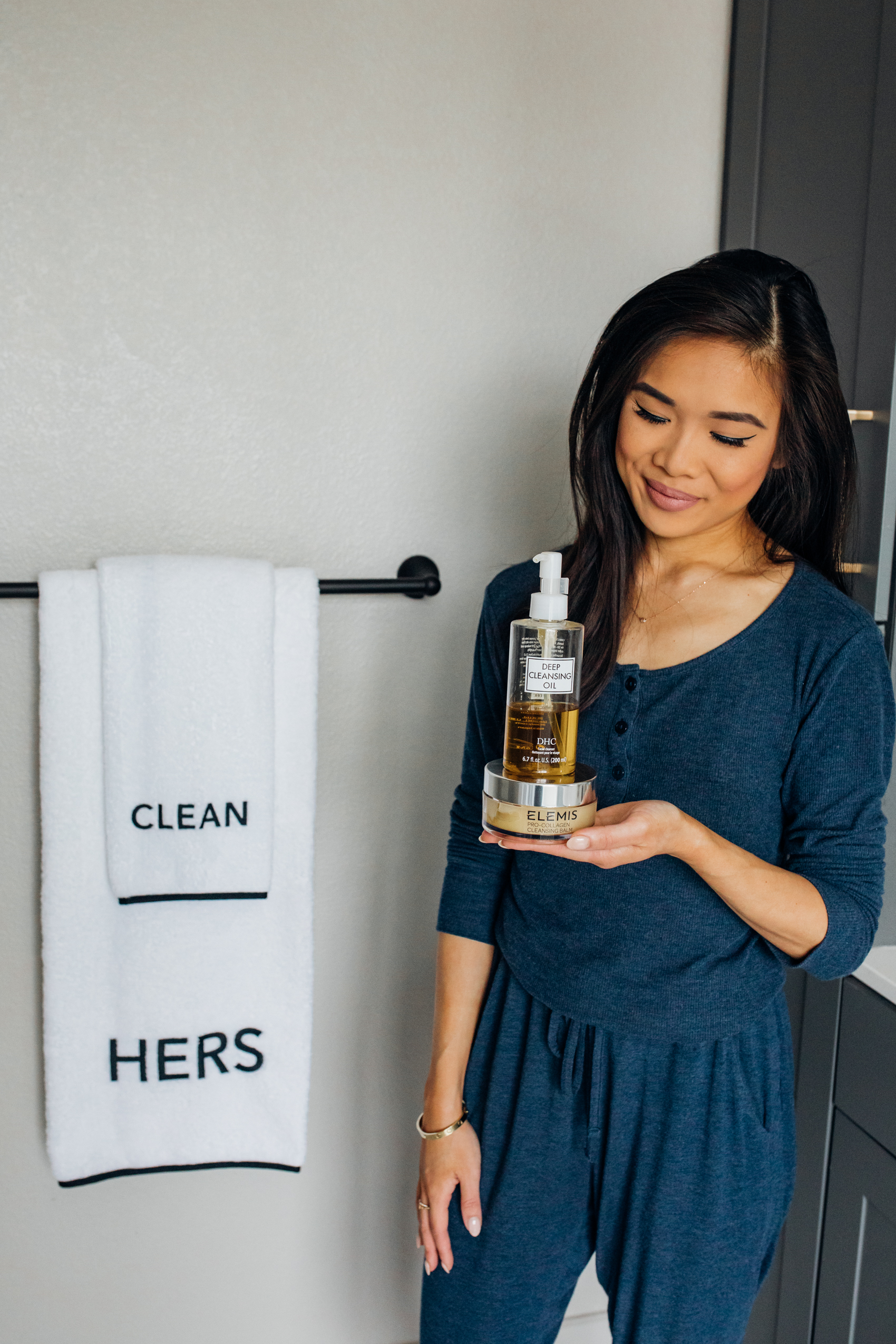Blogger Hoang-Kim shares how she removes her makeup during her nighttime skincare routine in her Dallas apartment bathroom with Weezie his and hers towels, wearing Tommy John loungewear