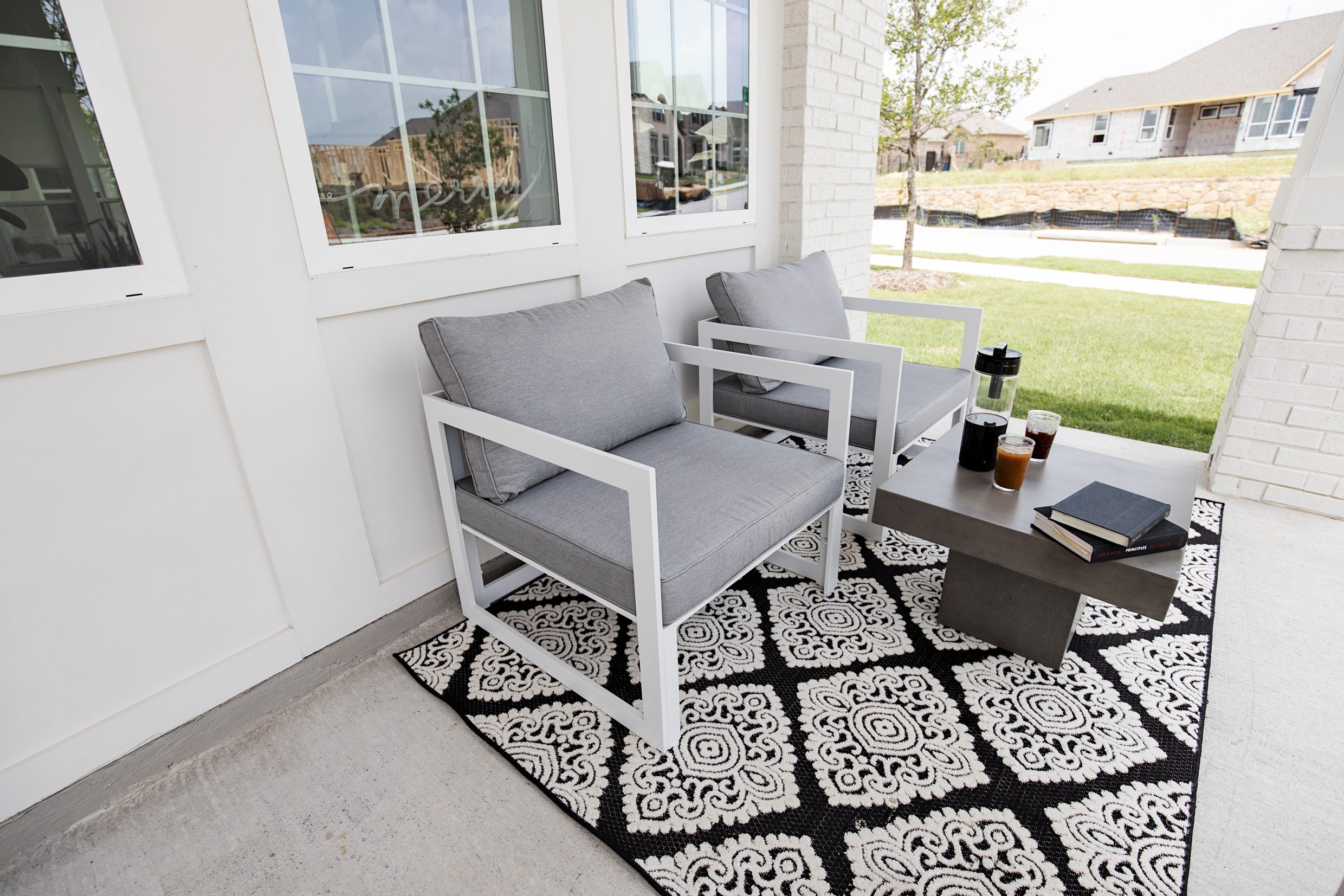 Modway modern outdoor chairs, black and white indoor outdoor rug, concrete coffee table for front yard patio