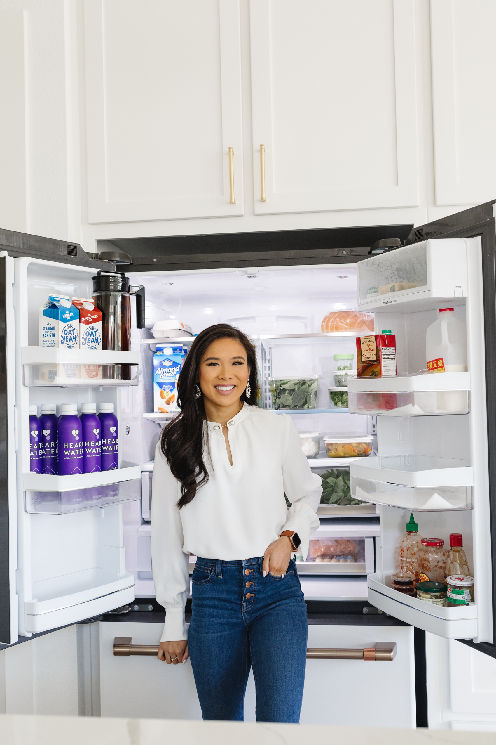 Blogger Hoang-Kim with her Cafe Appliances refrigerator in matte white with brushed bronze handles