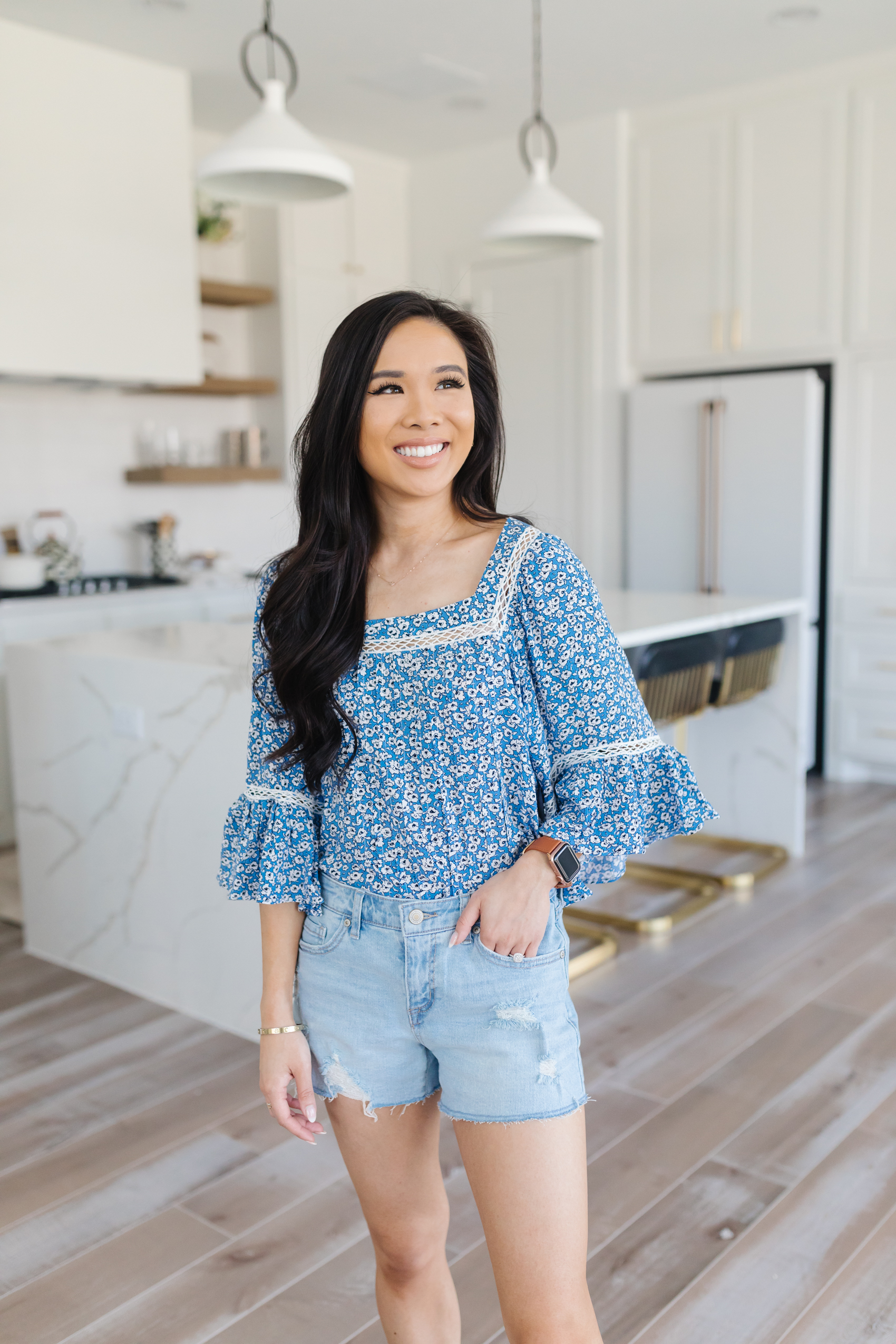 Blogger Hoang-Kim styles a floral long sleeve top with distressed shorts for a summer outfit from Walmart