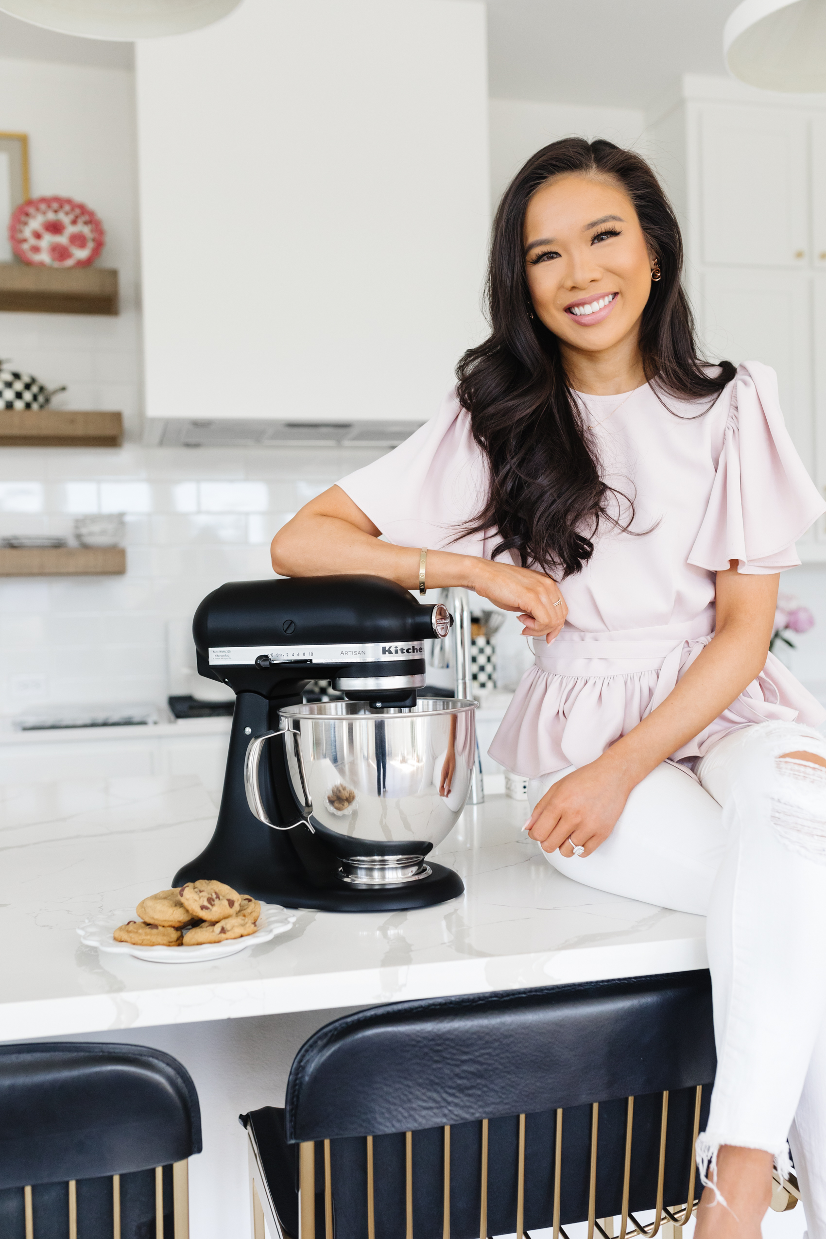 Blogger Hoang-Kim in her white kitchen with a matte Black Kitchenaid Mixer artisan series