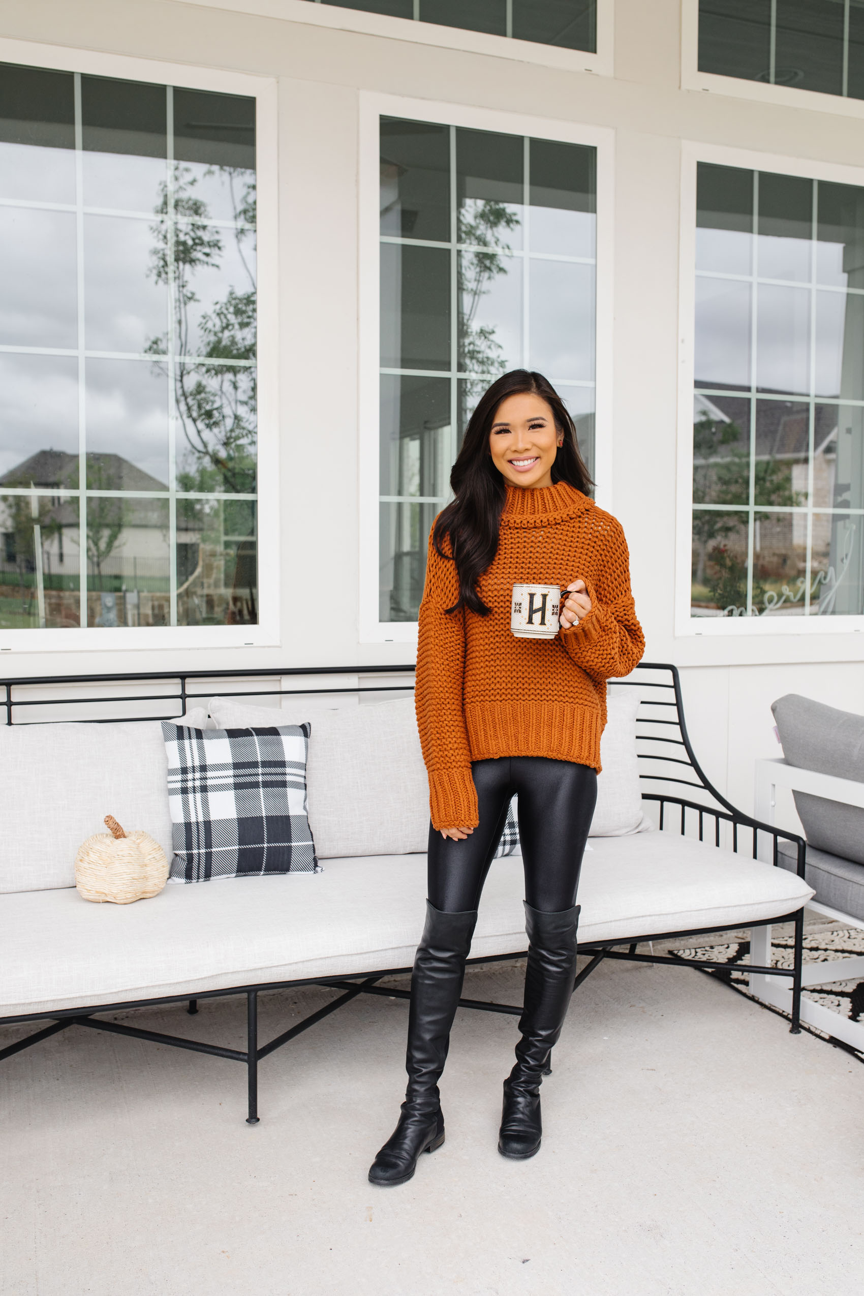 Blogger Hoang-Kim shares her affordable fall front porch decor including plaid pillows, faux pumpkins