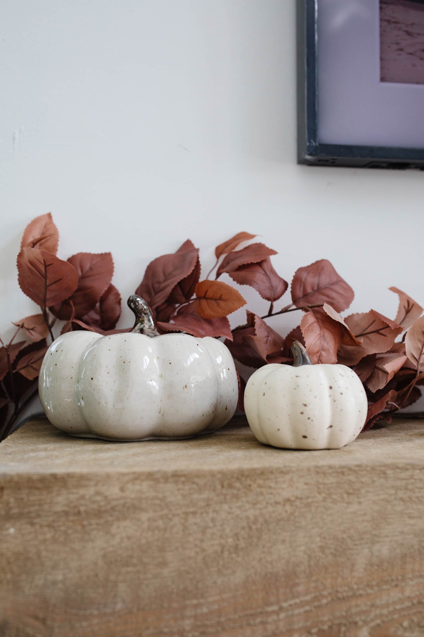 White pumpkins and a leaf garland for fall home decor