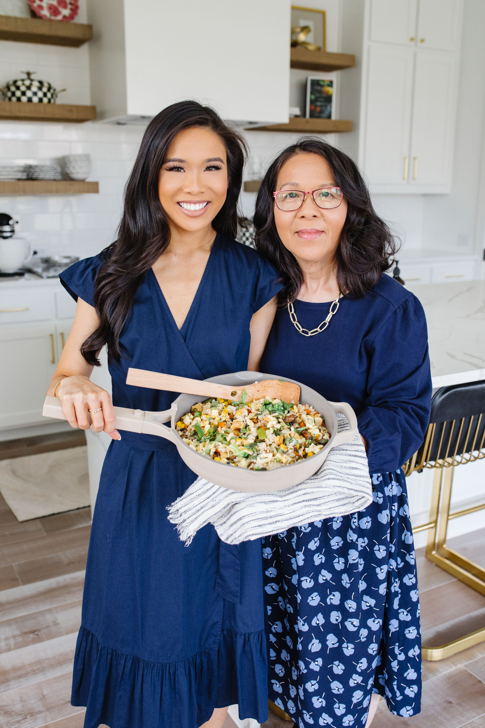 Blogger Hoang-Kim and her Mom Thuy-Tien share their Vietnamese fried rice recipe wearing Draper James Dresses in a white kitchen