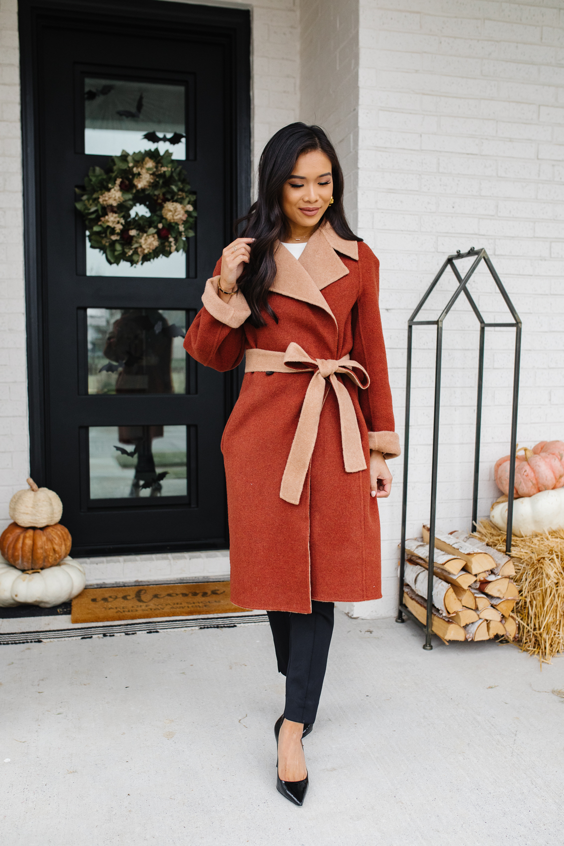 Blogger Hoang-Kim wearing a reversible coat by M.M.LaFleur with the best black pants and heels for a fall outfit