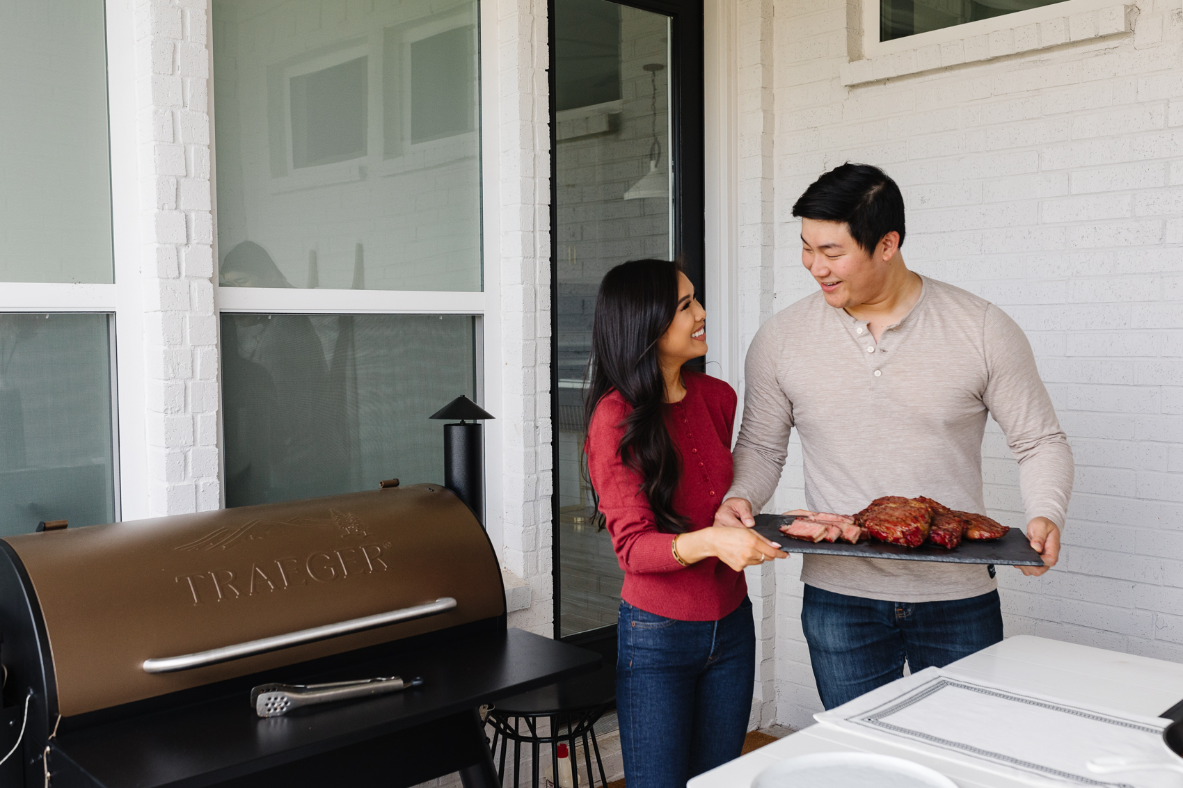 Blogger Hoang-Kim and her fiance Johnny on their backyard patio with the Traegar Pro 34