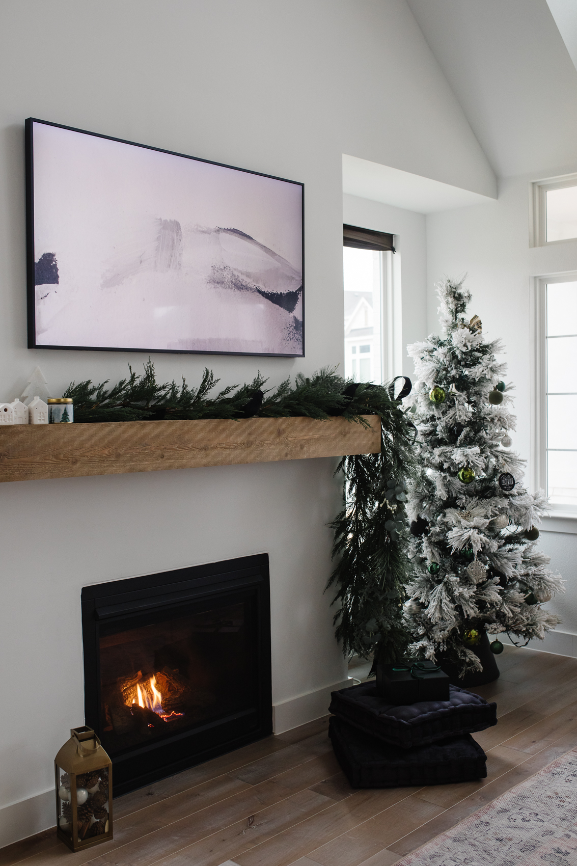 Christmas decor ideas from blogger Hoang-Kim Cung including an asymmetrical cypress garland and a Balsam Hill flocked tree