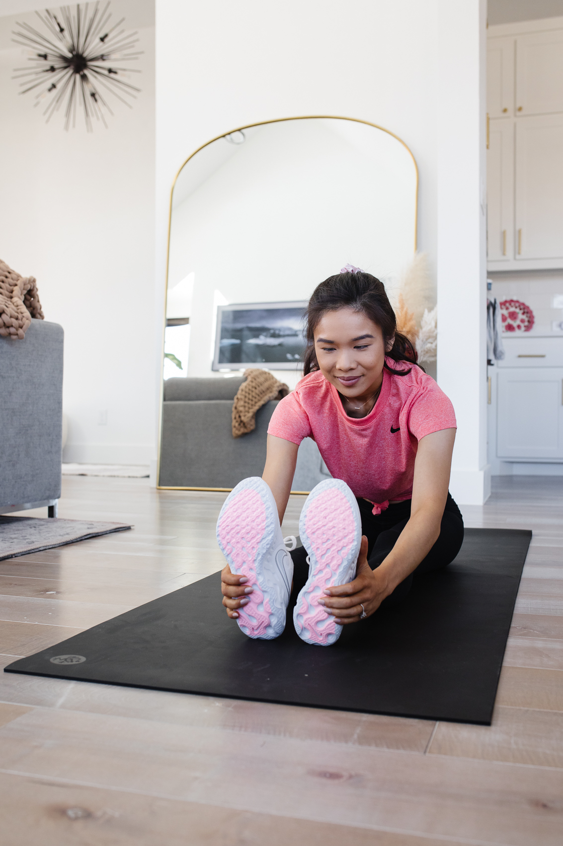 Blogger Hoang-Kim stretching on her manduka yoga mat
